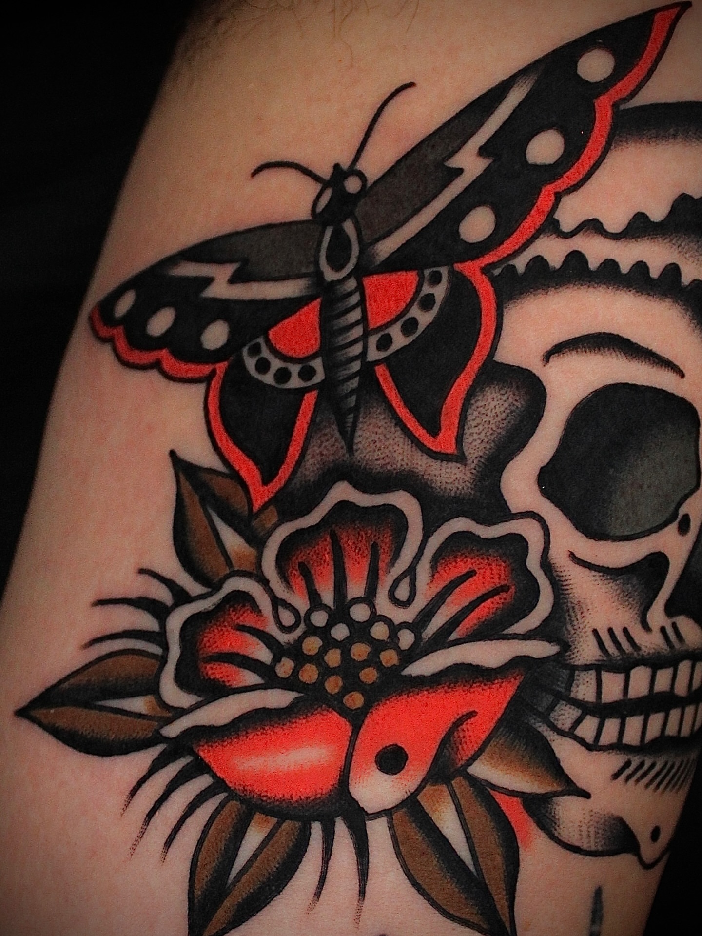 Skull and moth American traditional tattoo on the forearm by Dustin Stemen, Charlotte, North Carolina