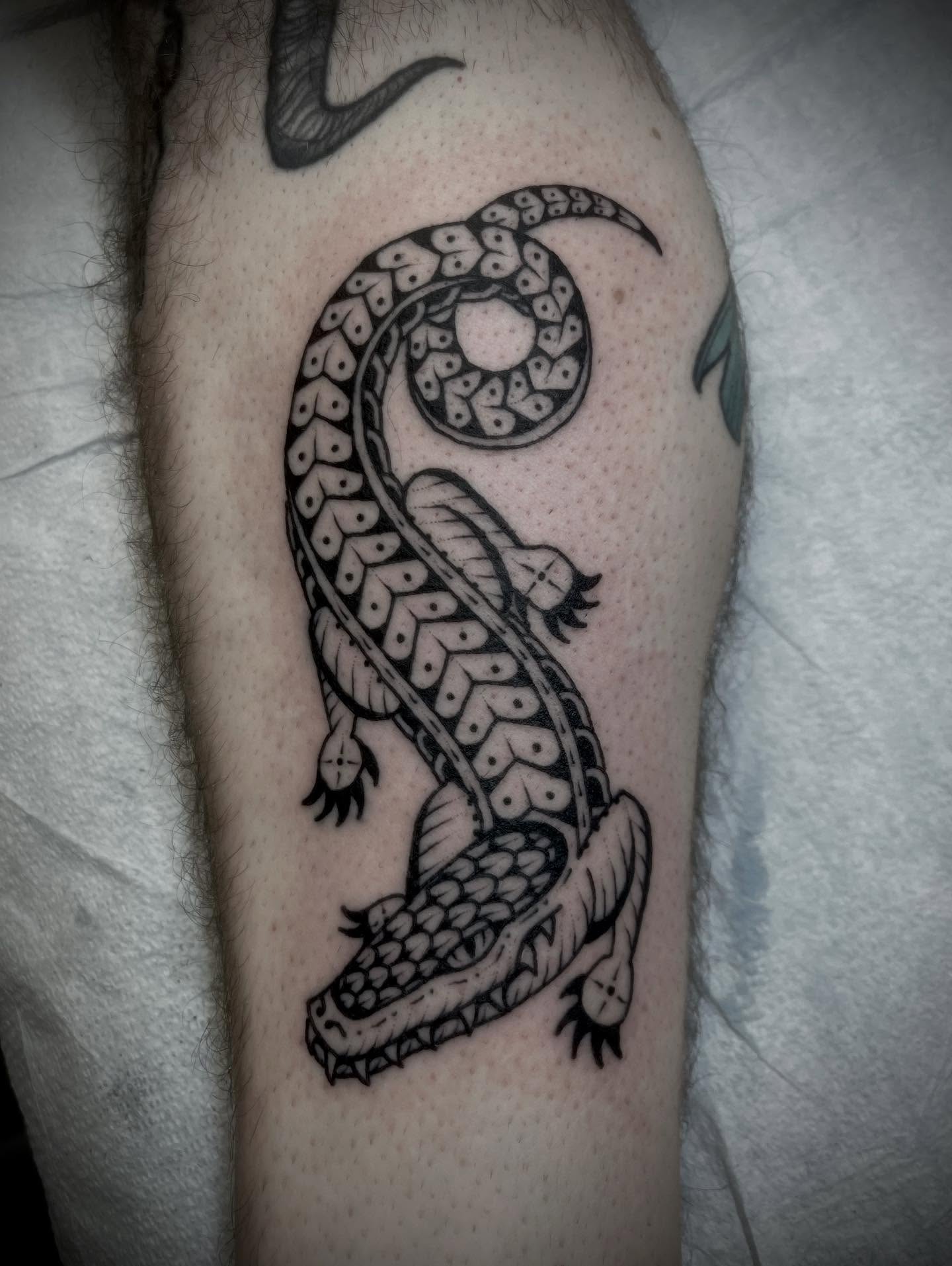 Serpent black and grey tattoo on the forearm by Jason Ryan