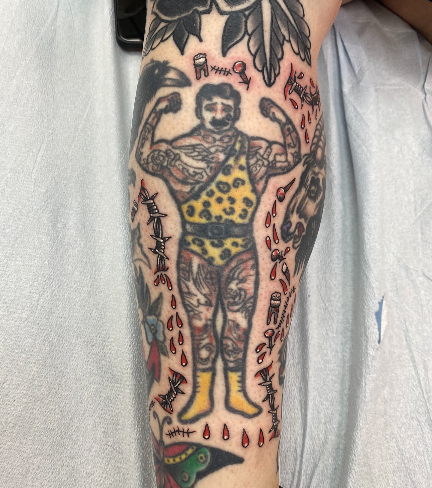 Strongman American traditional tattoo on the forearm by Mike Tapia