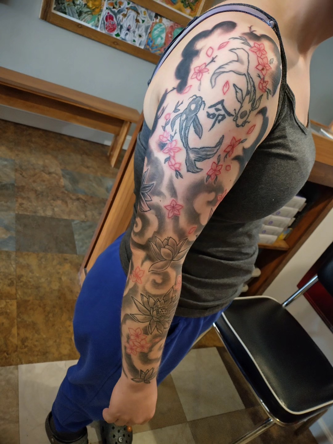 Koi fish and blossoms japanese irezumi tattoo on the upper arm by Matt Williamson