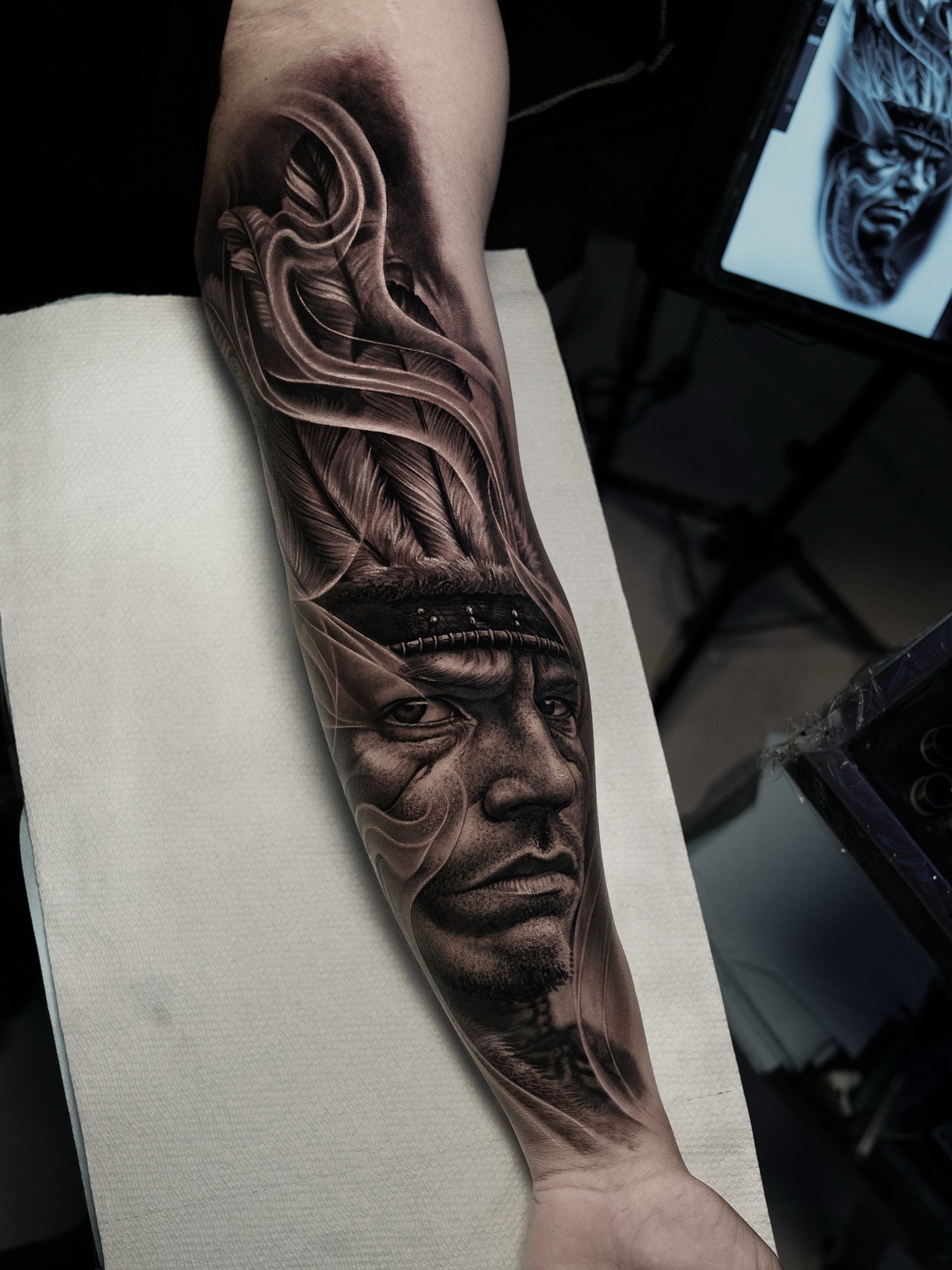 Native American portrait with feathers surrealism tattoo on the forearm by @_garart_