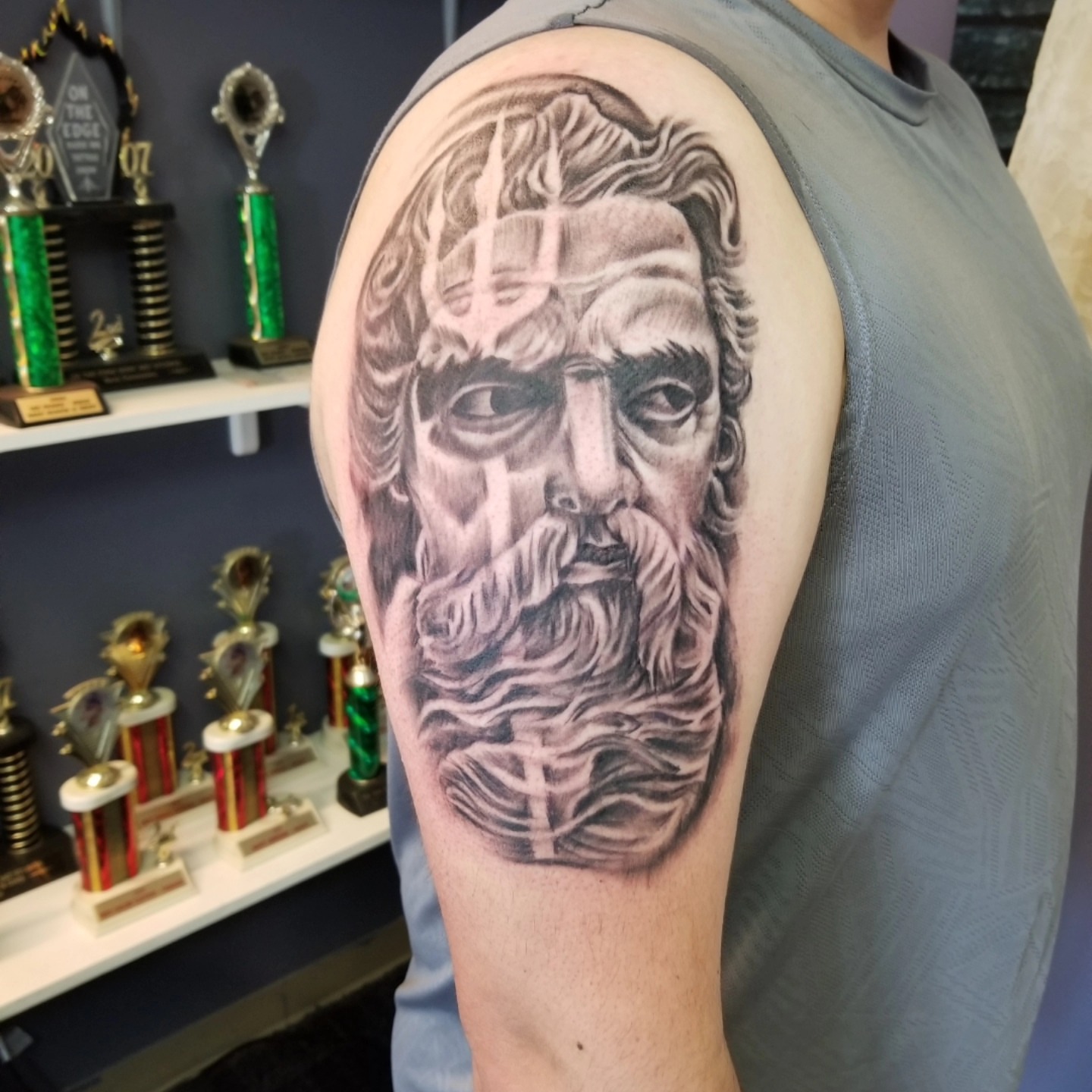 Bearded man realism tattoo on the upper arm by Dennis Foust