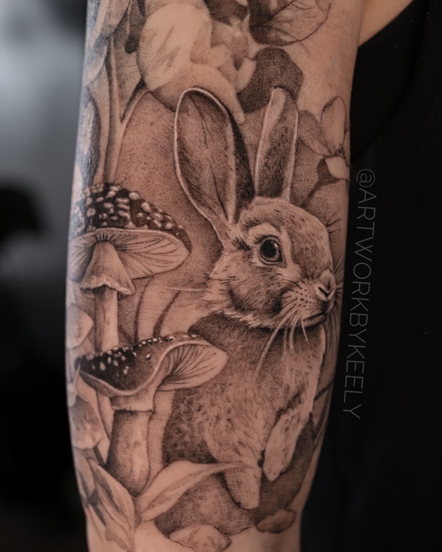 Rabbit and mushrooms fine line tattoo on the forearm by Keely Thompson