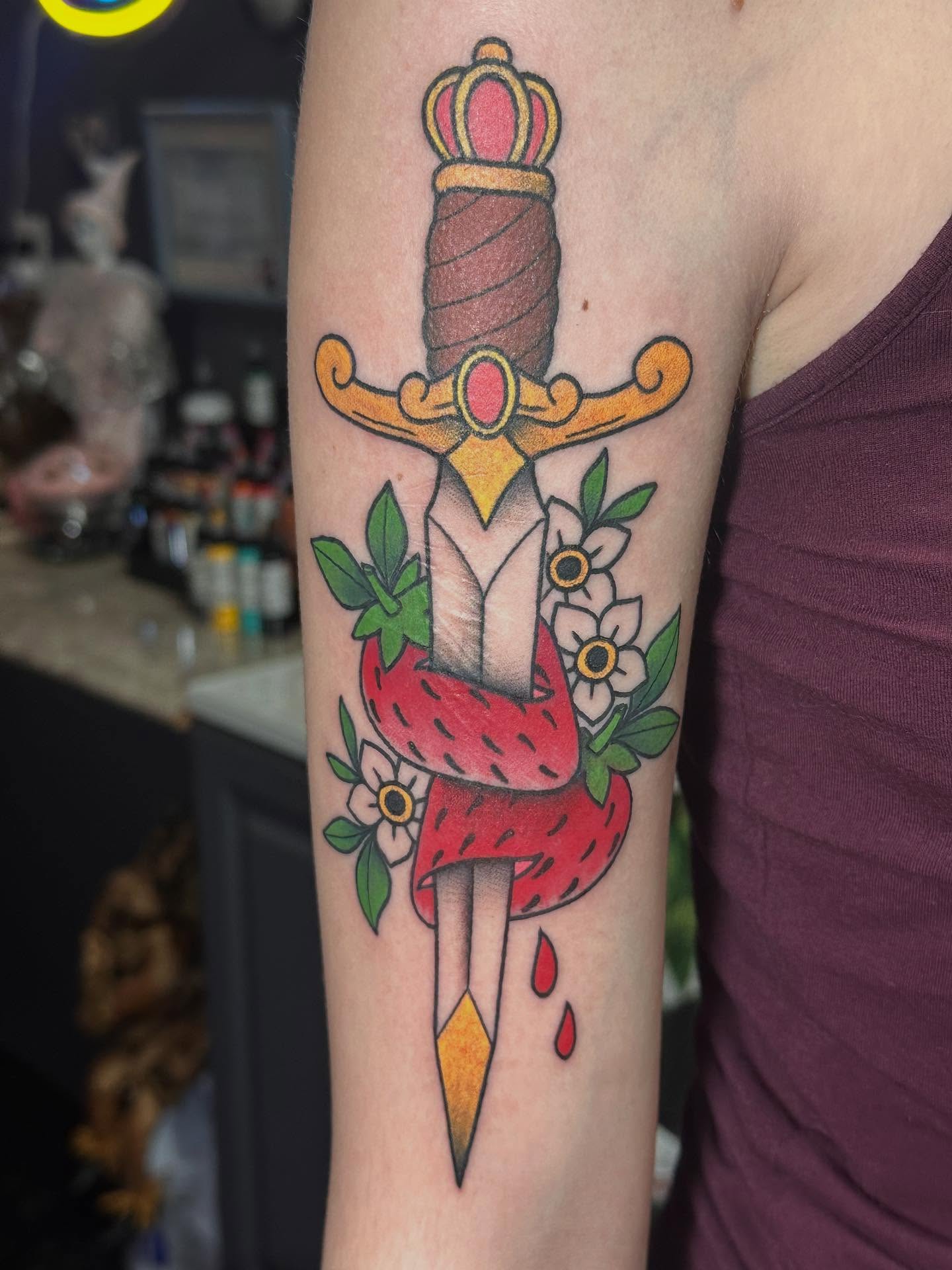 Sword with strawberry American traditional tattoo on the forearm by Tattoo artist