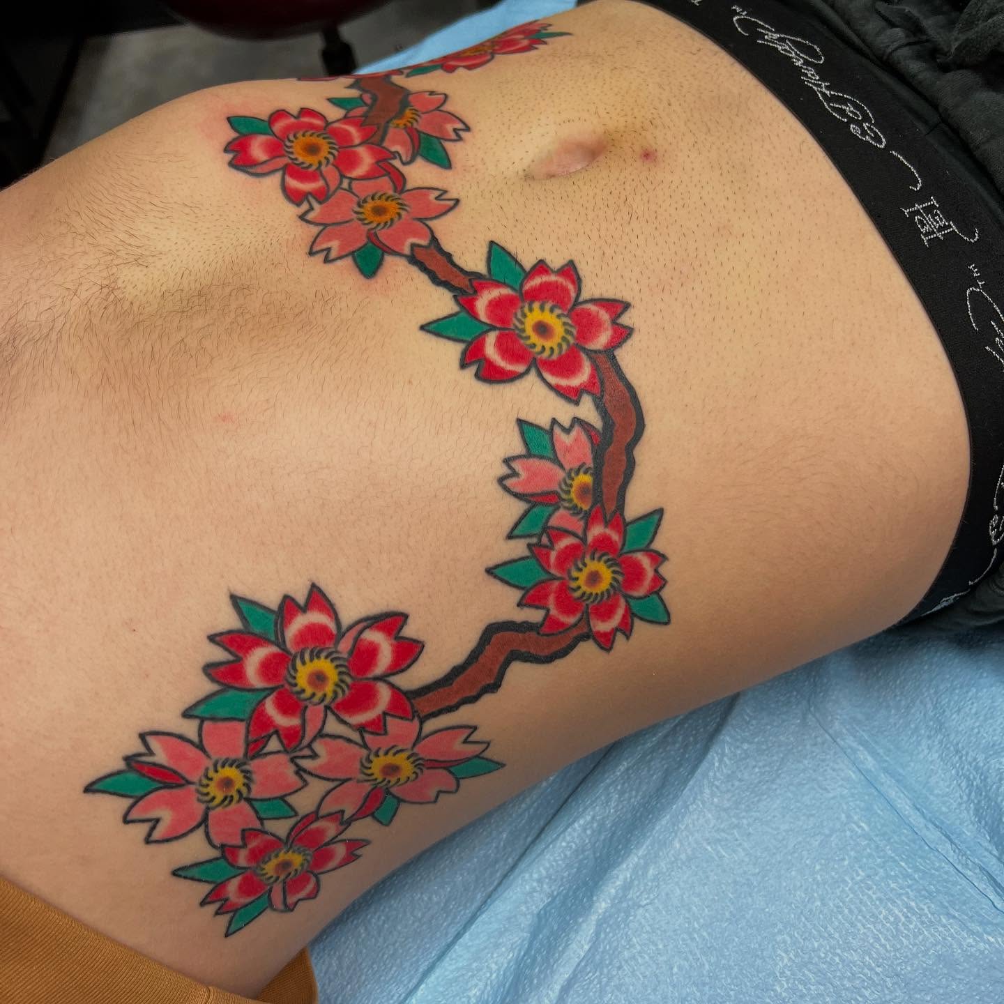 Cherry blossoms American traditional tattoo on the thigh by doodle