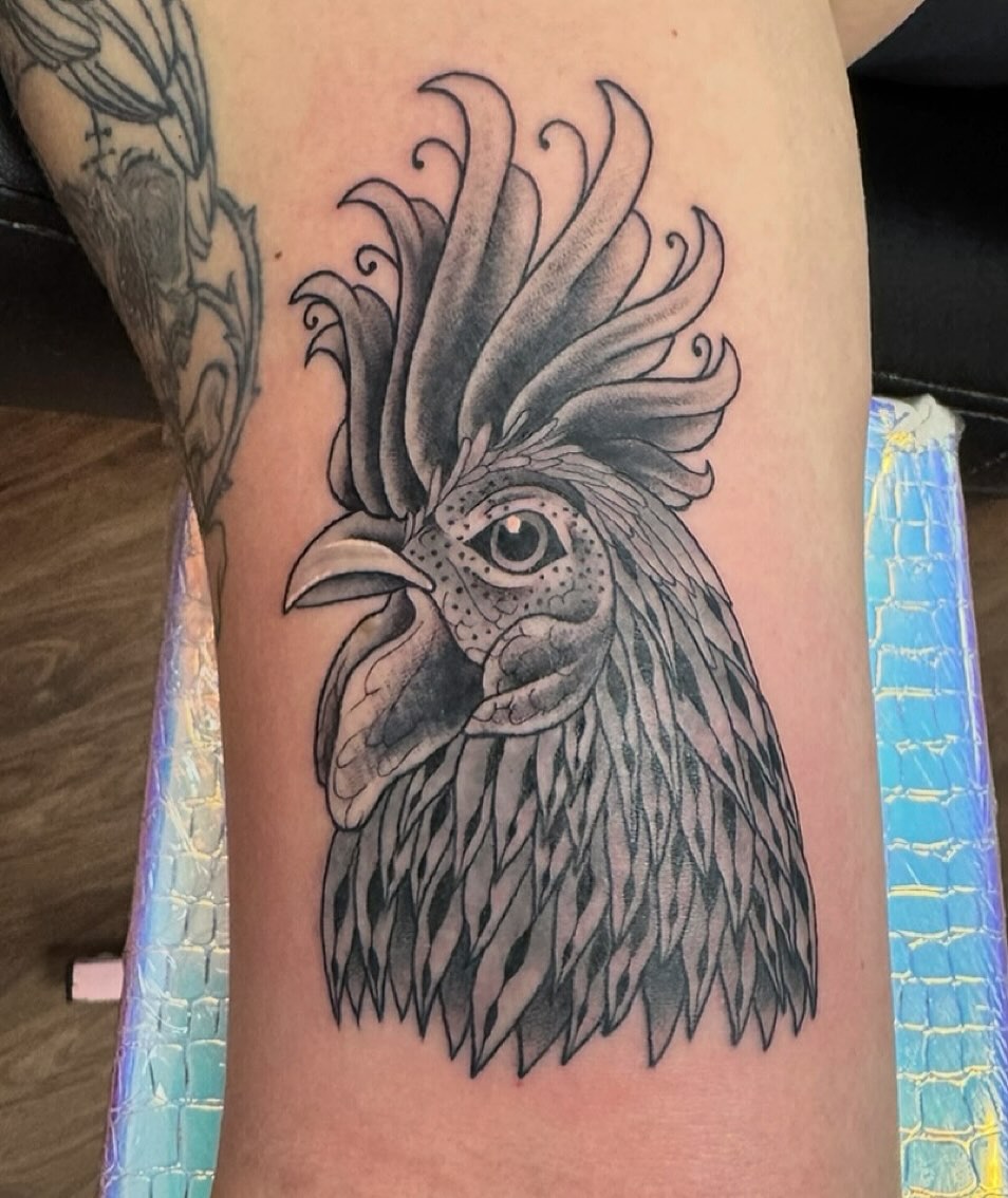 Rooster head black and grey tattoo on the forearm by McKenna Chalifoux