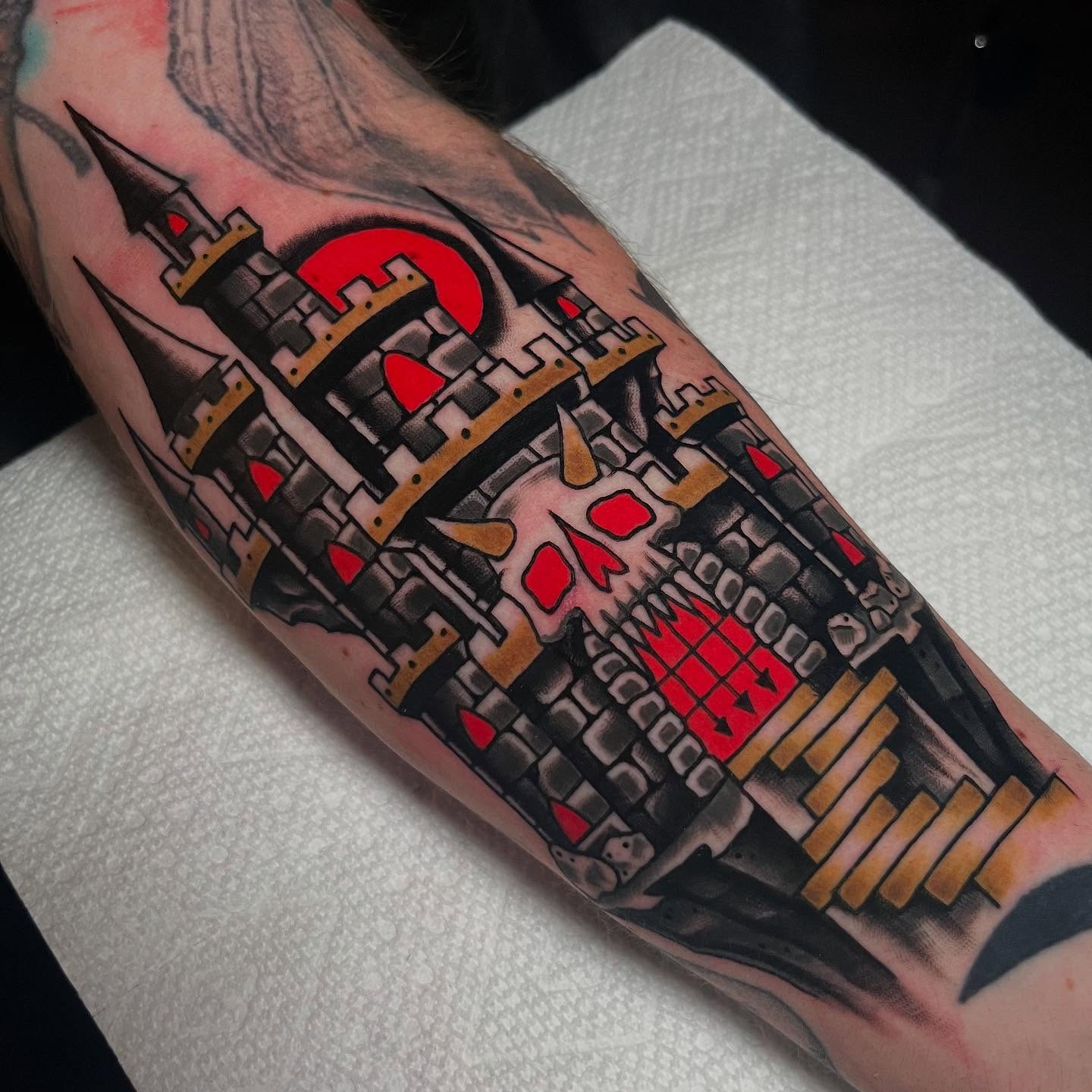 Castle and skull American traditional tattoo on the forearm by Sara Lewis