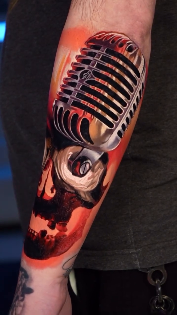 Skull with vintage microphone realism tattoo on the forearm by B R A D C H A R L e S