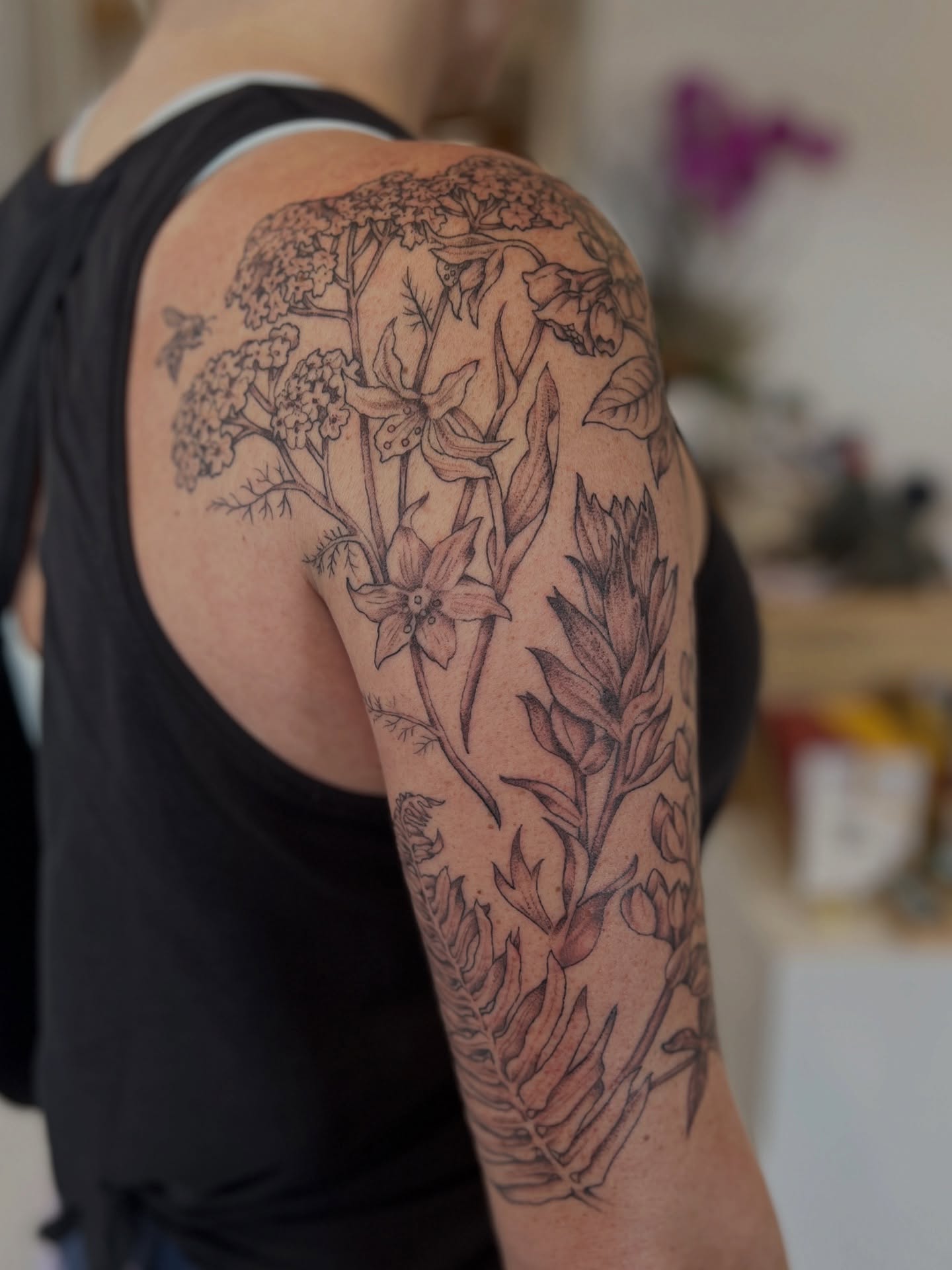 Botanical black and grey tattoo on the upper arm by Kelsi Hooper, Seattle, Washington
