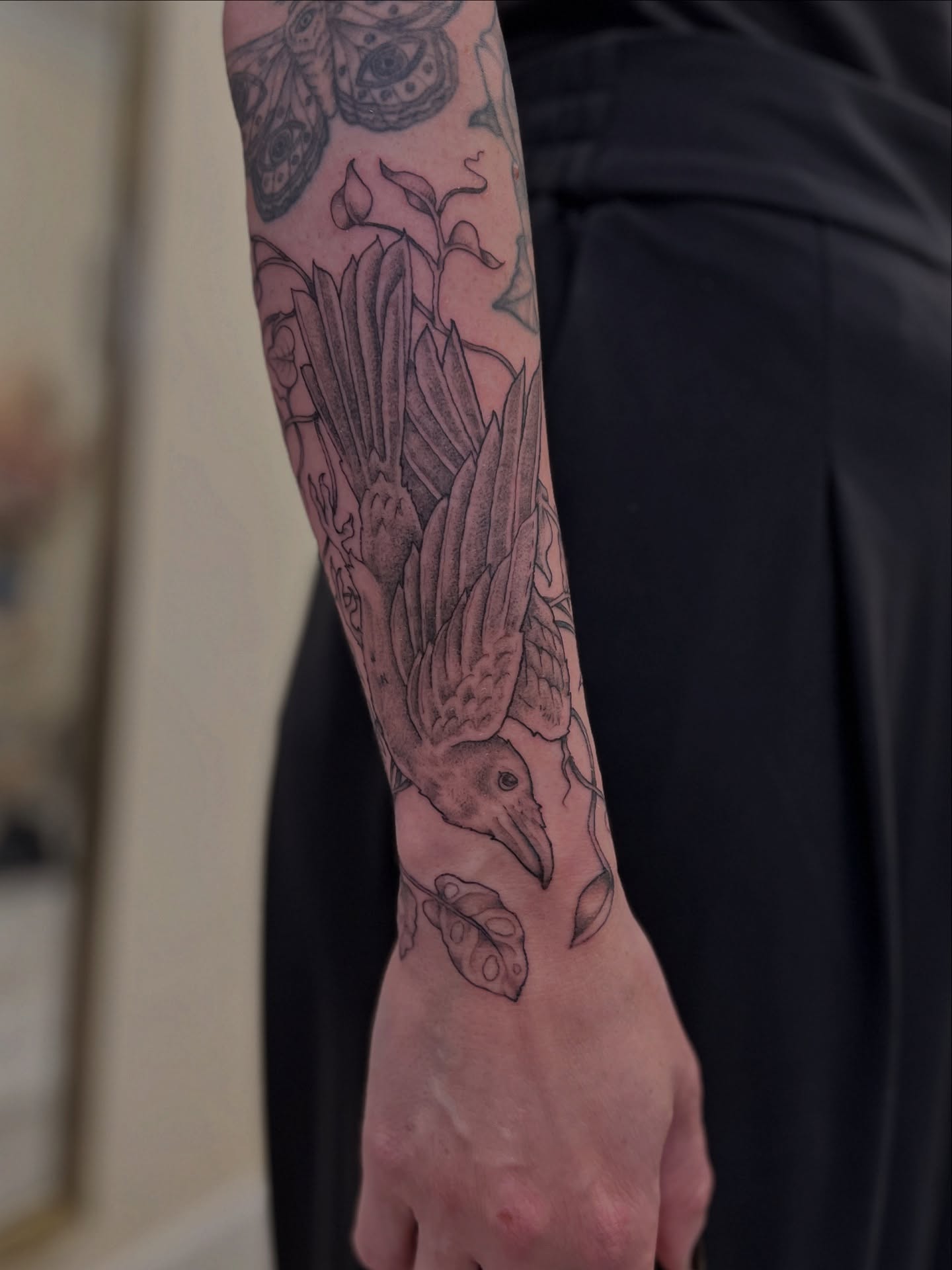 Bird and flowers black and grey tattoo on the forearm by Kelsi Hooper, Seattle, Washington