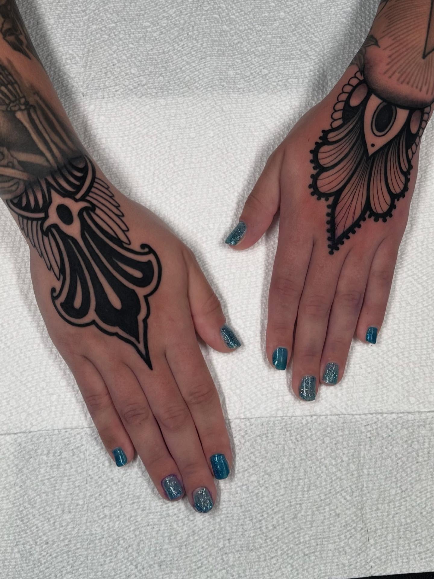 Moth black and grey tattoo on the hand by Henry Gaßner