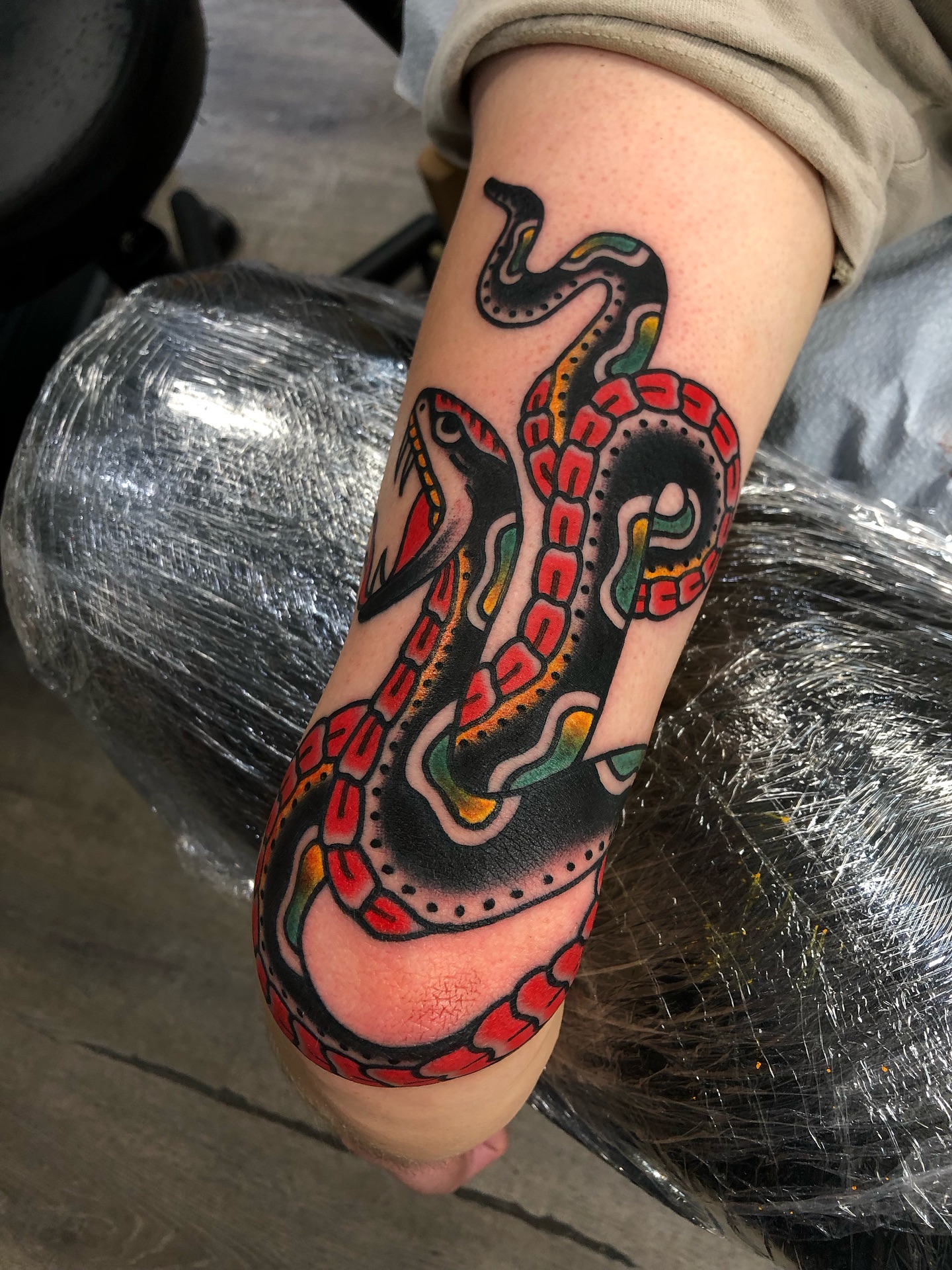 Snake American traditional tattoo on the forearm by Nick Sharratt, Chicago, Illinois