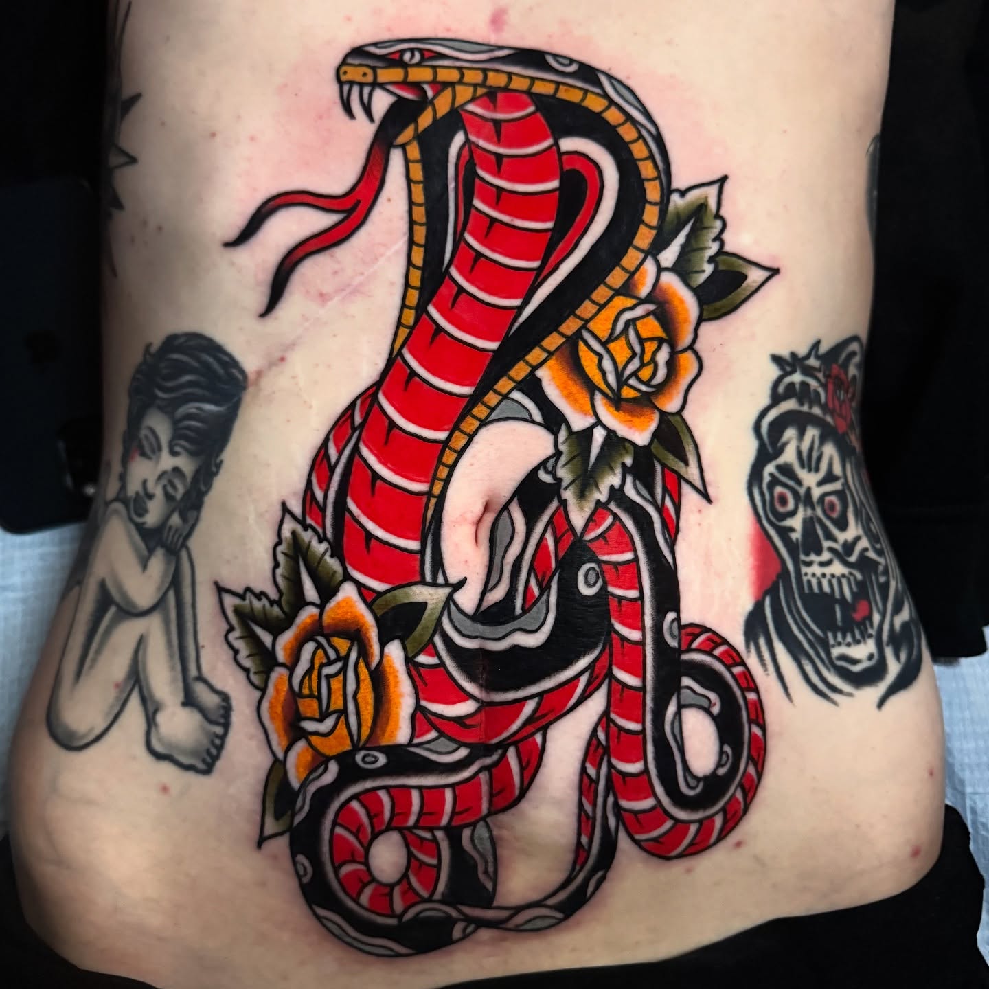 Snake and roses American traditional tattoo on the ribs by K y l e   M a c K e n z i e, Salem, Massachusetts