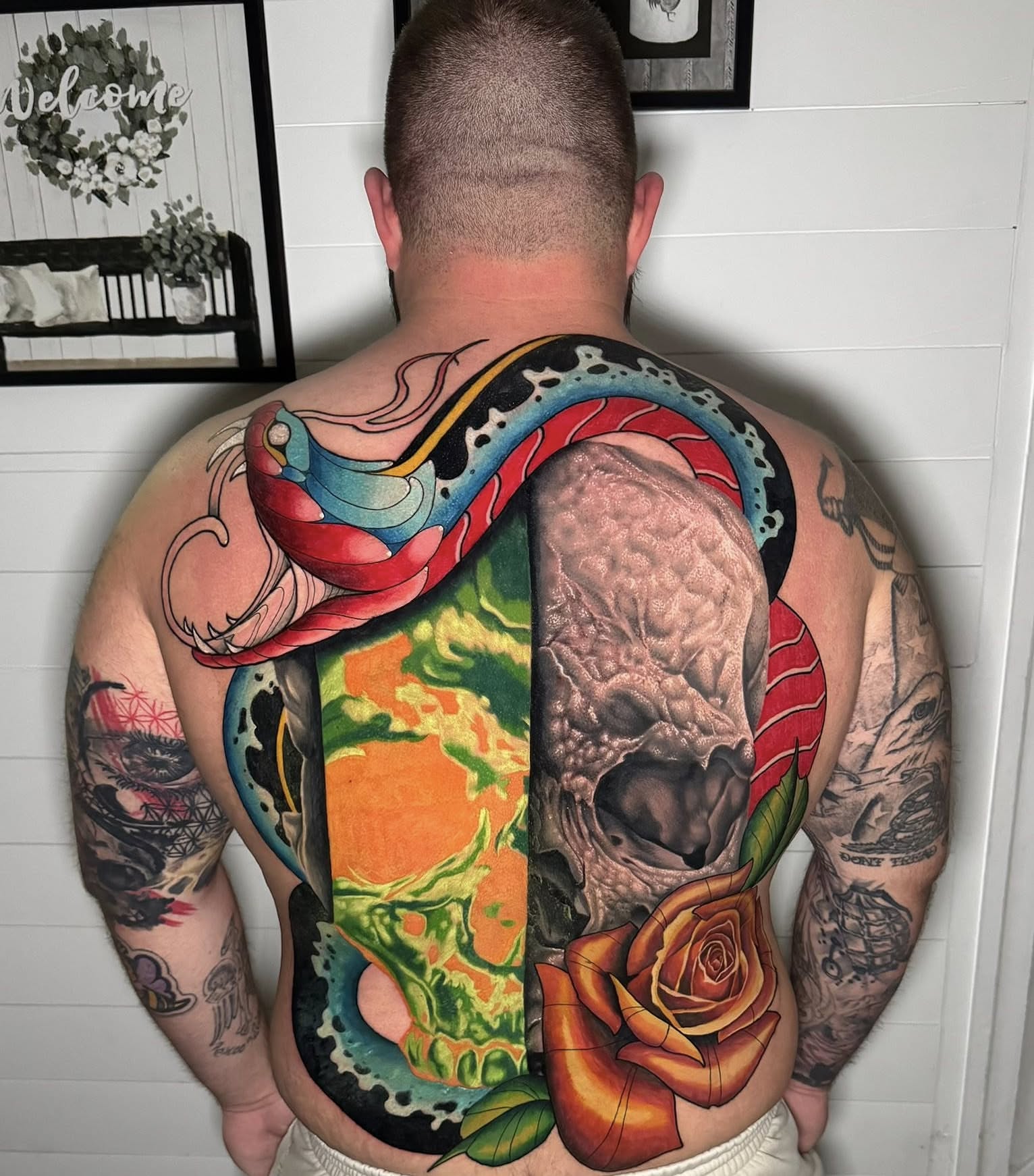 Skull and snake American traditional tattoo on the back by Bobby Hurst
