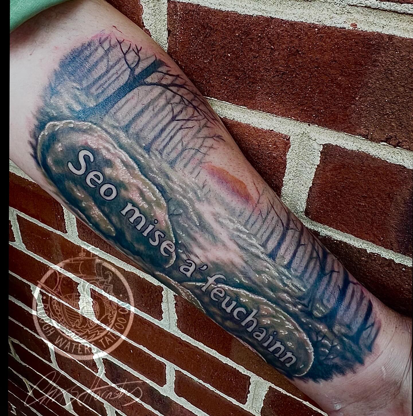 Landscape with tree and stone realism tattoo on the forearm by Chris Hornsby