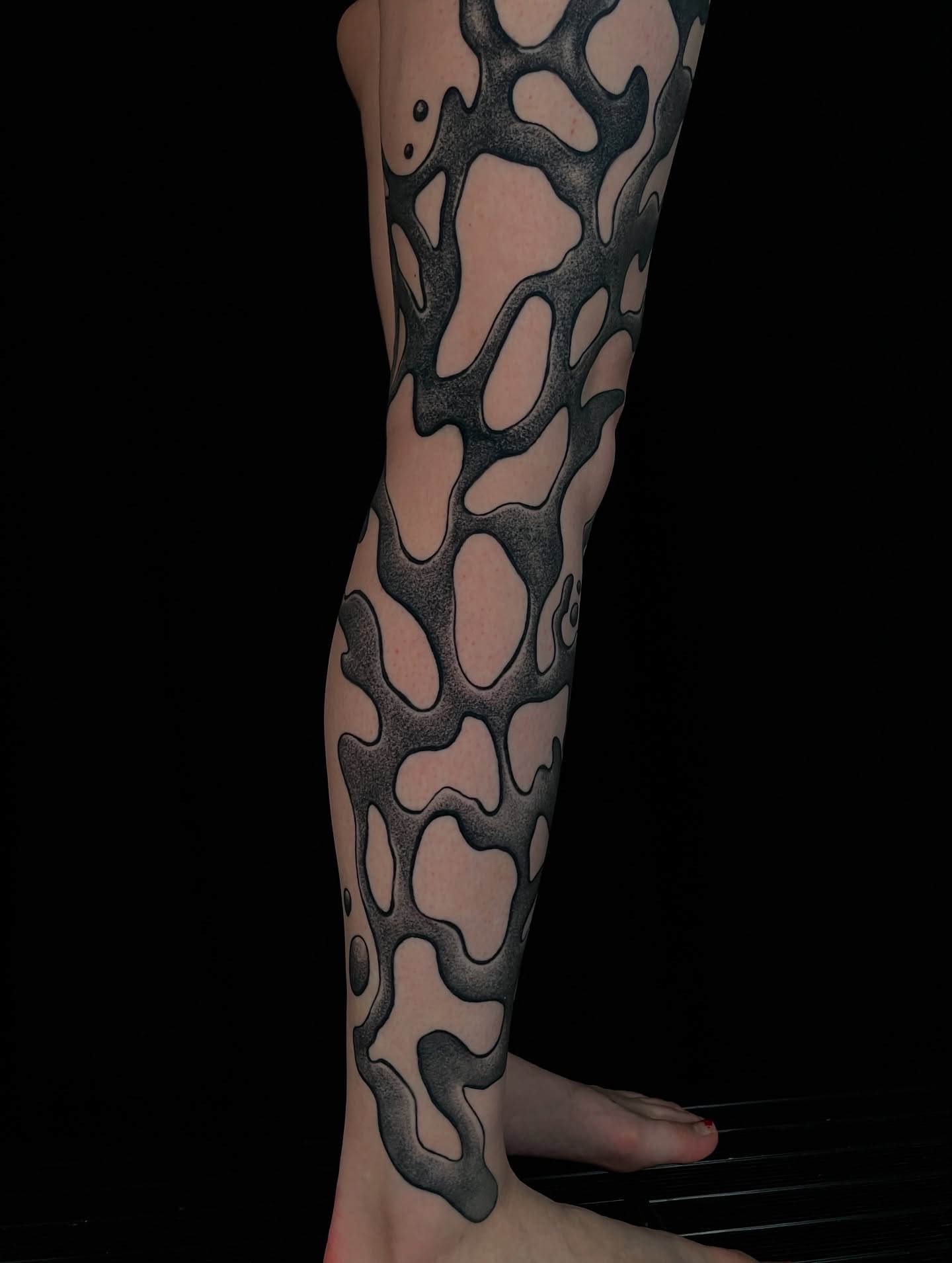 Abstract pattern black and grey tattoo on the calf by Austin Clark