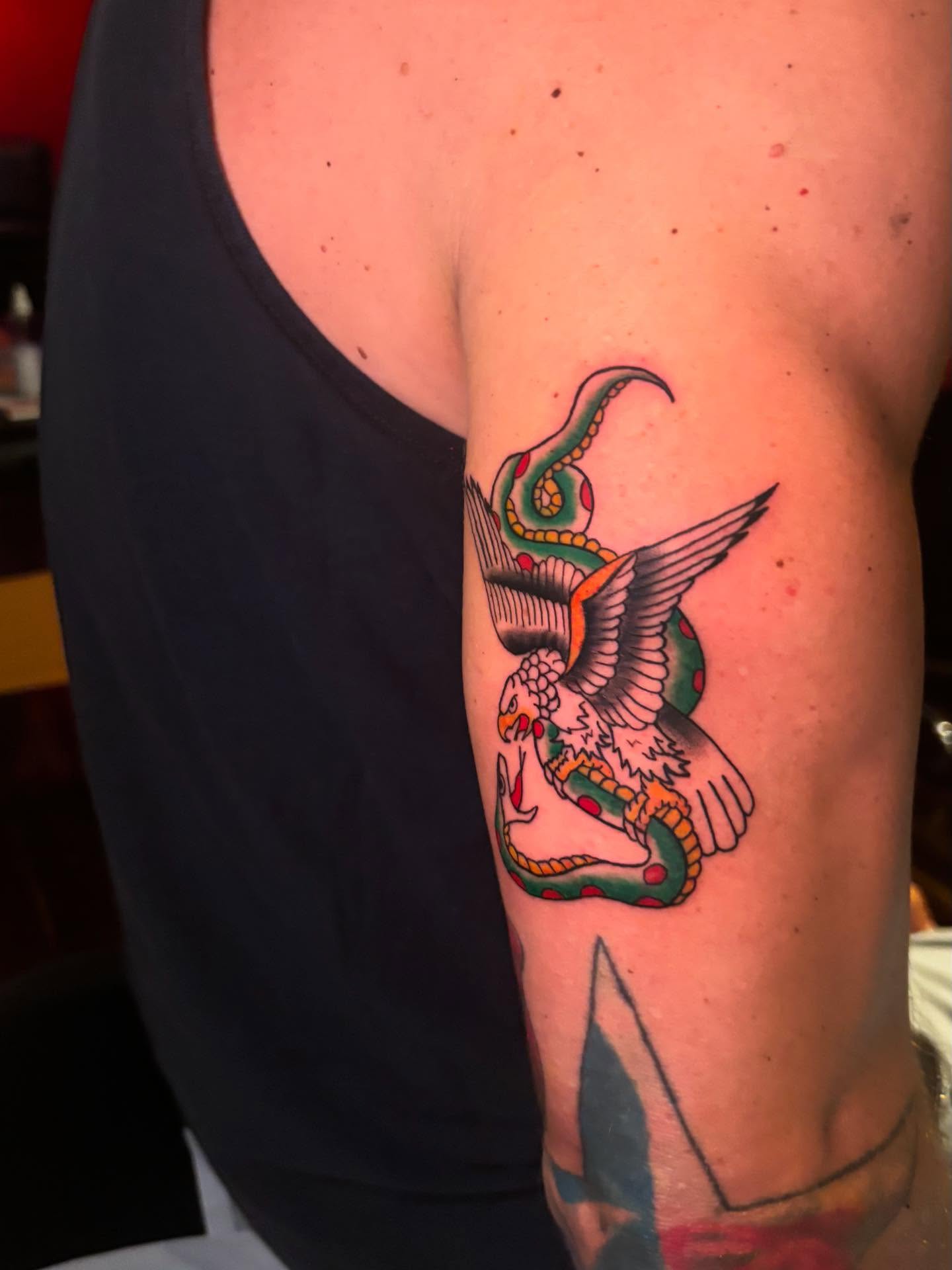 Eagle and snake American traditional tattoo on the forearm by Nyah Ramirez