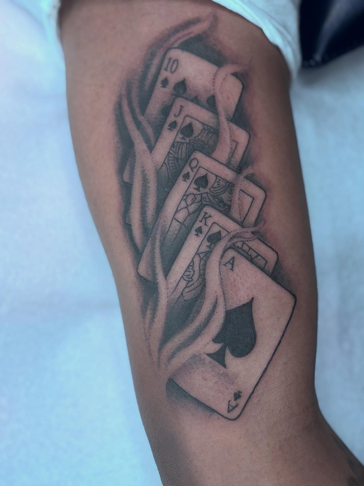 Playing cards black and grey tattoo on the forearm by π»πΈπ½π½, Ypsilanti, Michigan