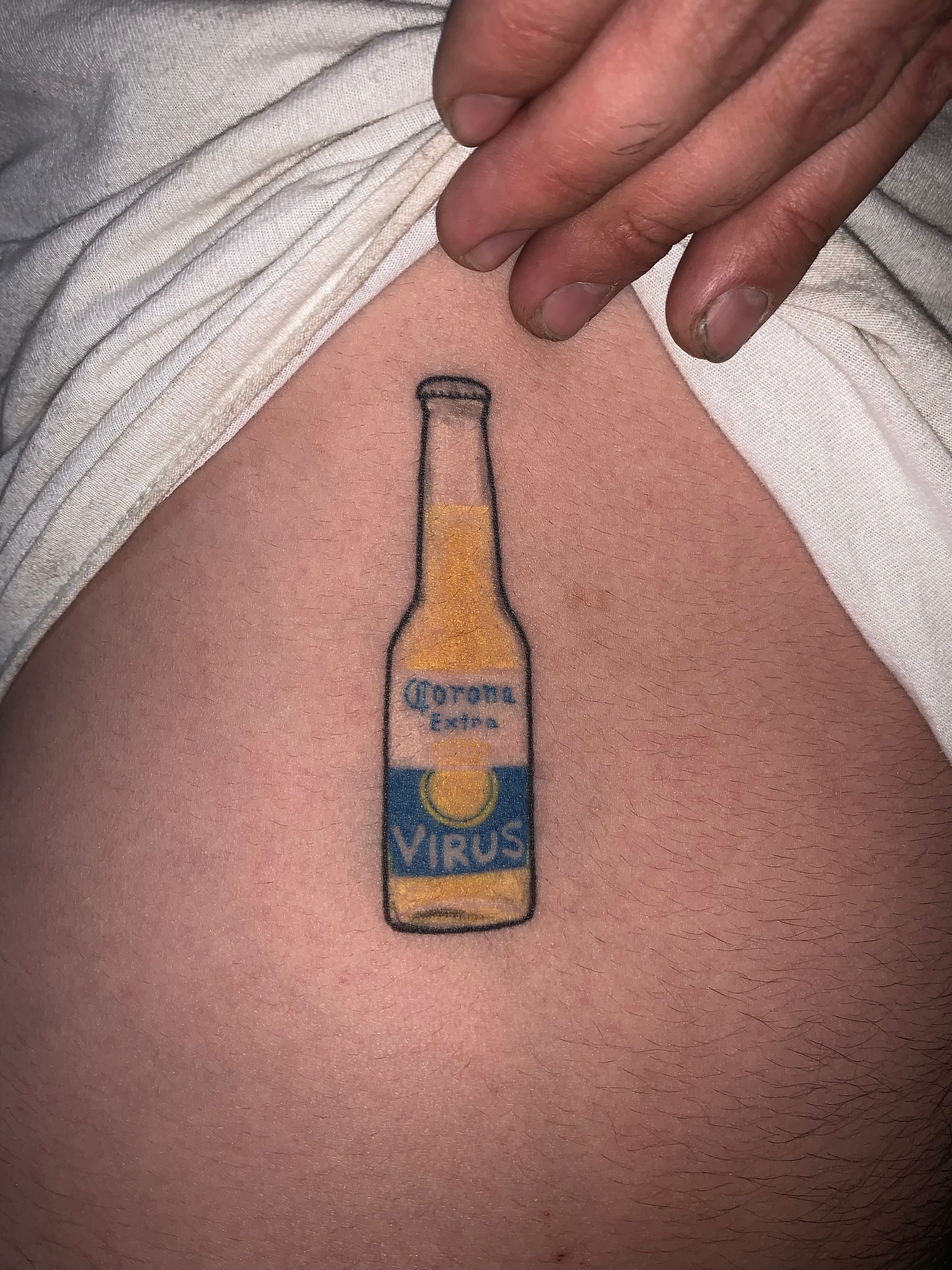 Corona Extra bottle realism tattoo on the thigh by Abel Ponce