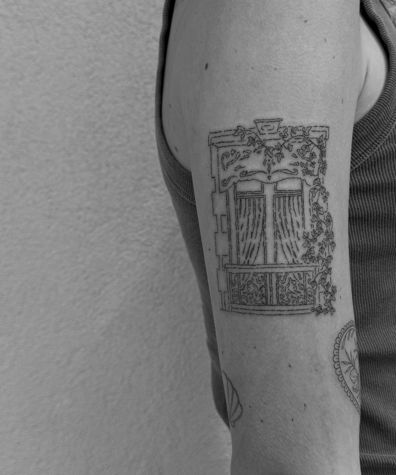 Window with ivy black and grey tattoo on the forearm by Abby Robinson