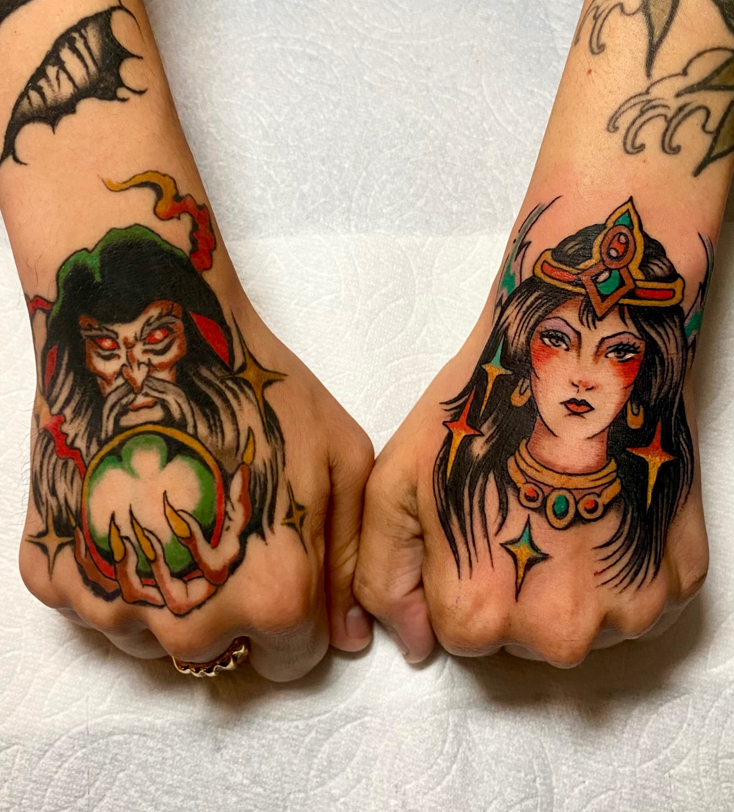 Wizard and woman American traditional tattoo on the hand by Haley Tucker, Sebastopol, California