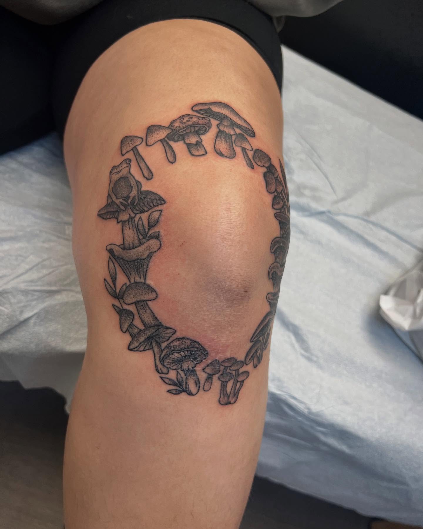 Mushroom circle black and grey tattoo on the thigh by Cody Marl
