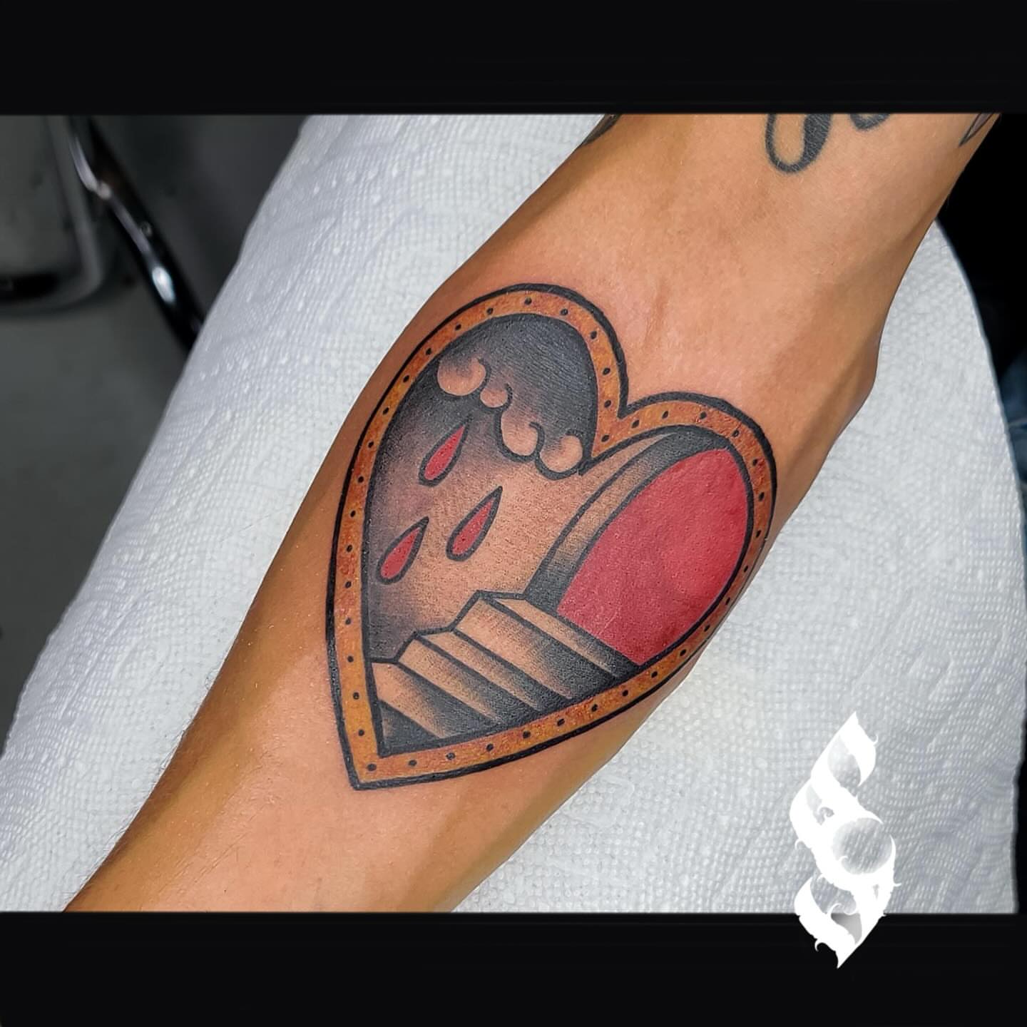 Heart with dripping blood American traditional tattoo on the forearm by Amanda Stampfly
