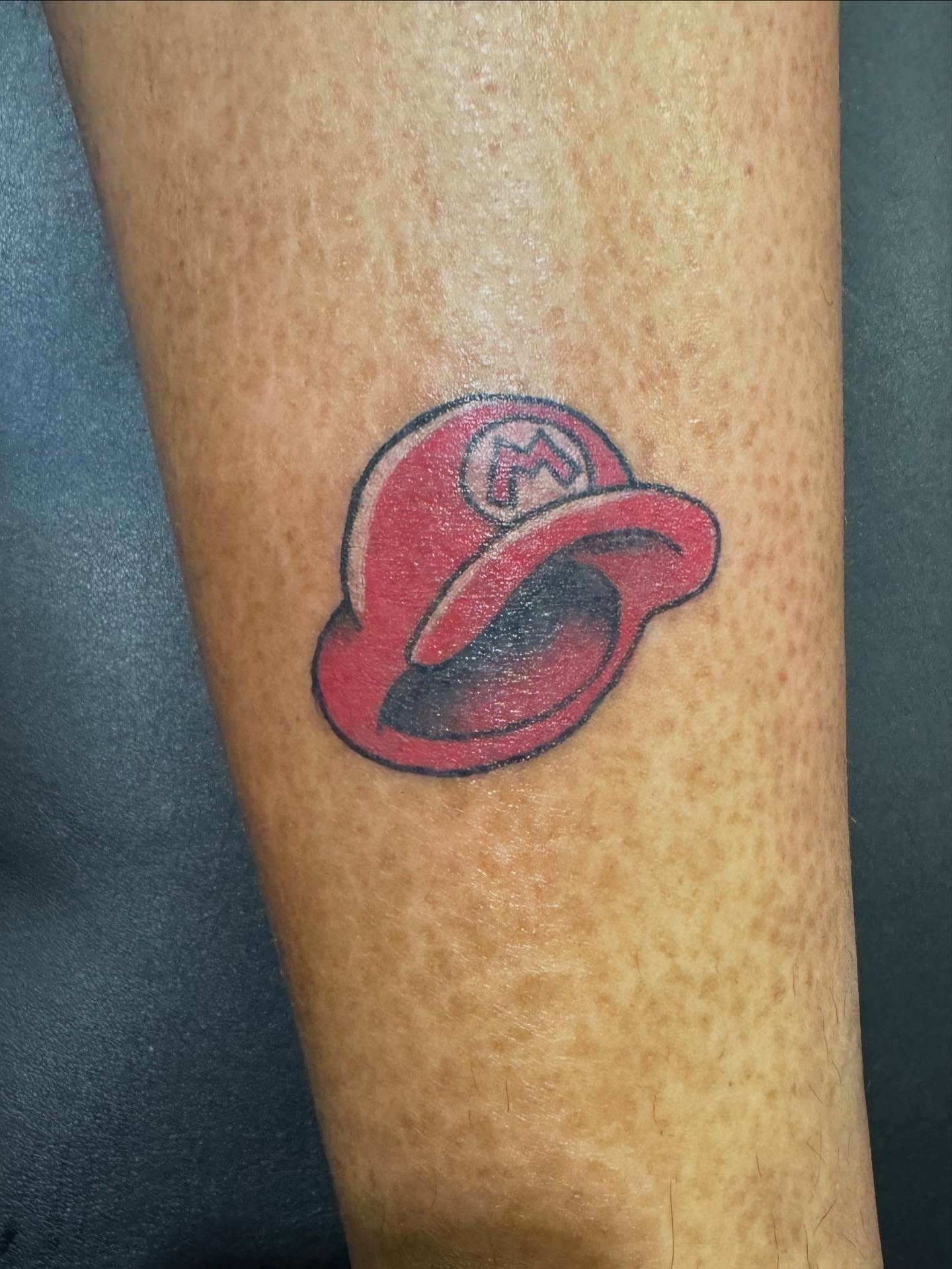 Mario hat American traditional tattoo on the forearm by 👾 not ur baby’s ink 👾