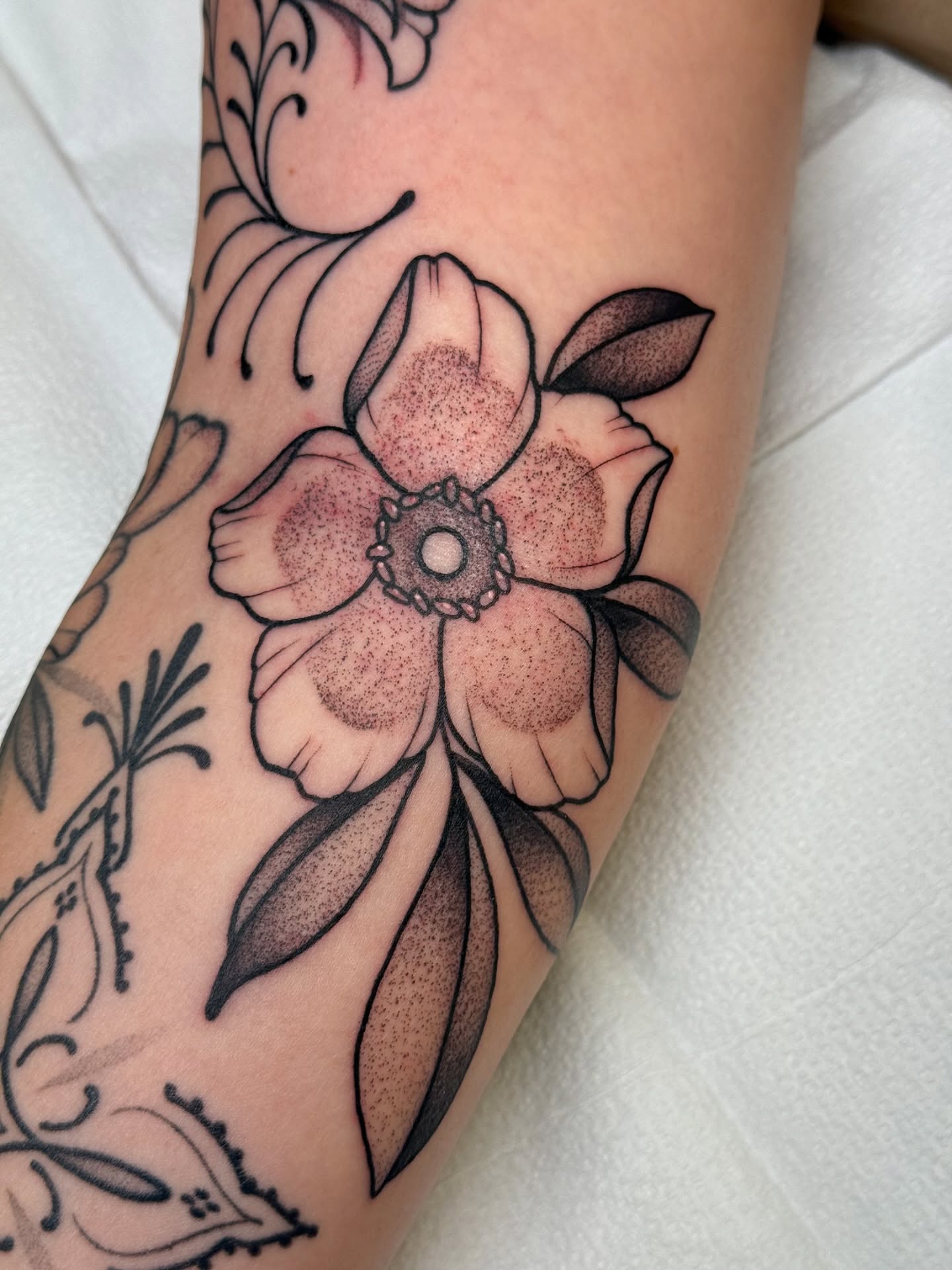 Flower black and grey tattoo on the forearm by Erin Shea