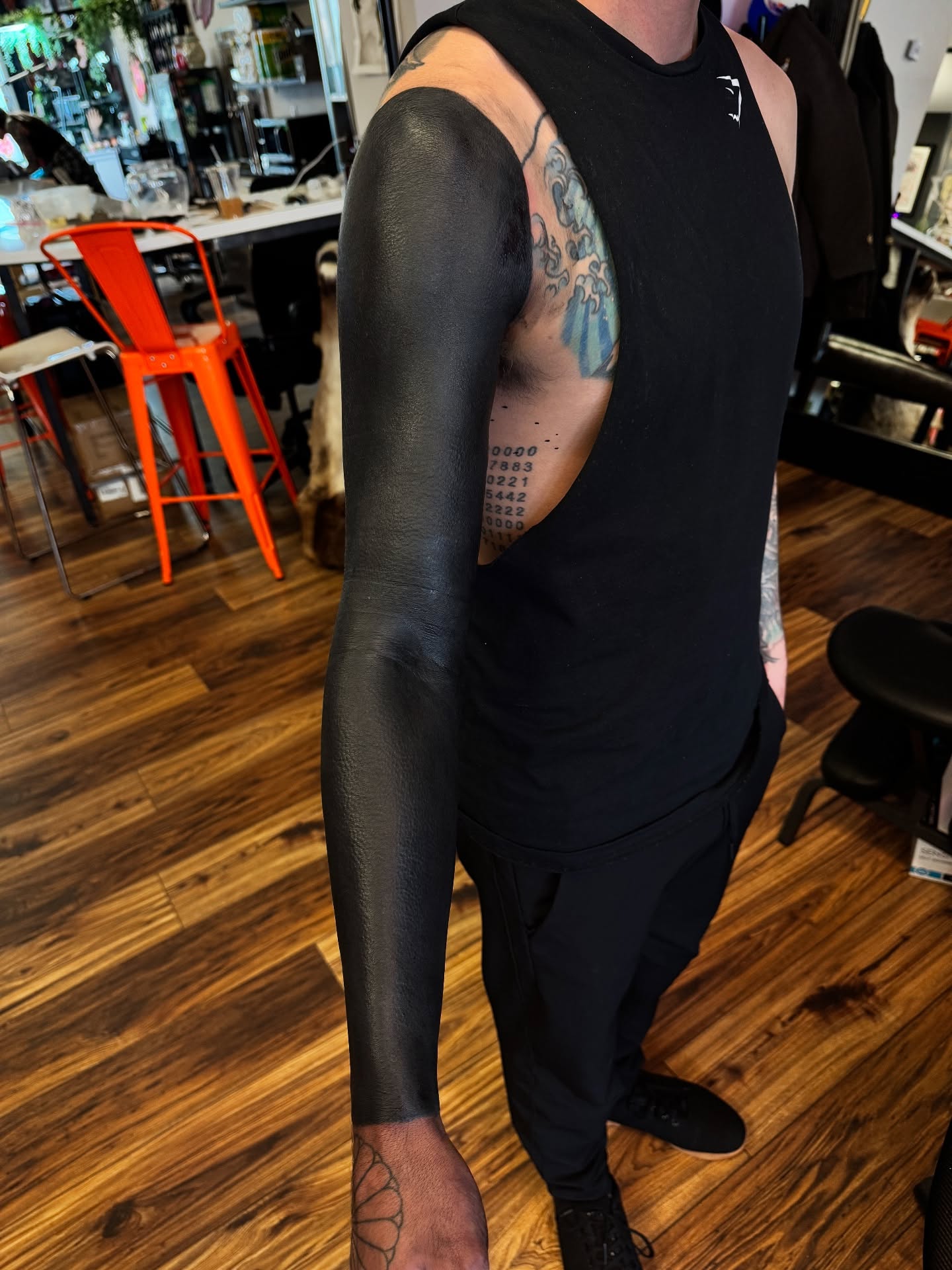 Numbers black and grey tattoo on the upper arm by Denver Blackout Tattoo Specialist - Anthony