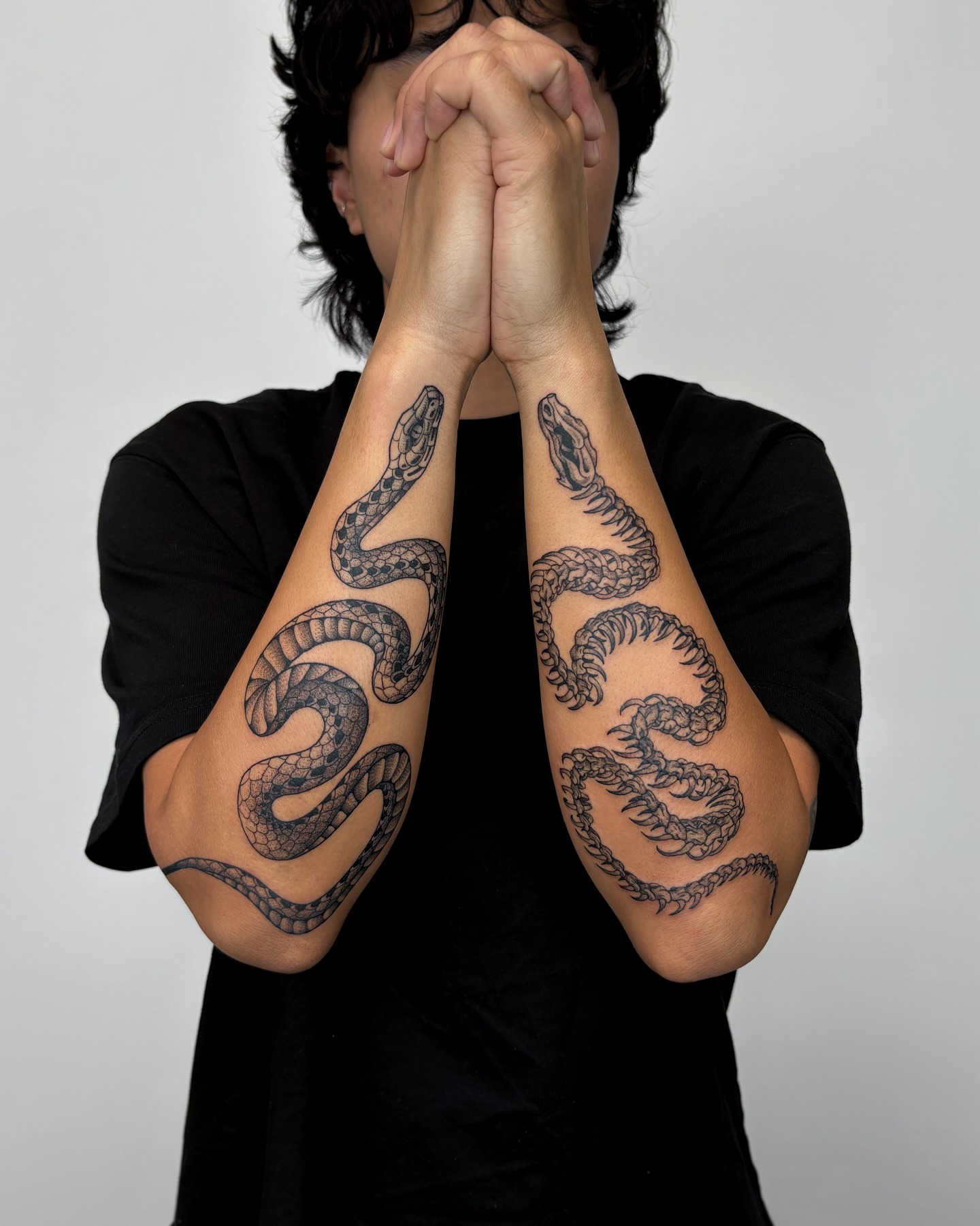 Snakes black and grey tattoo on the forearm by Kuya, Berkeley, California