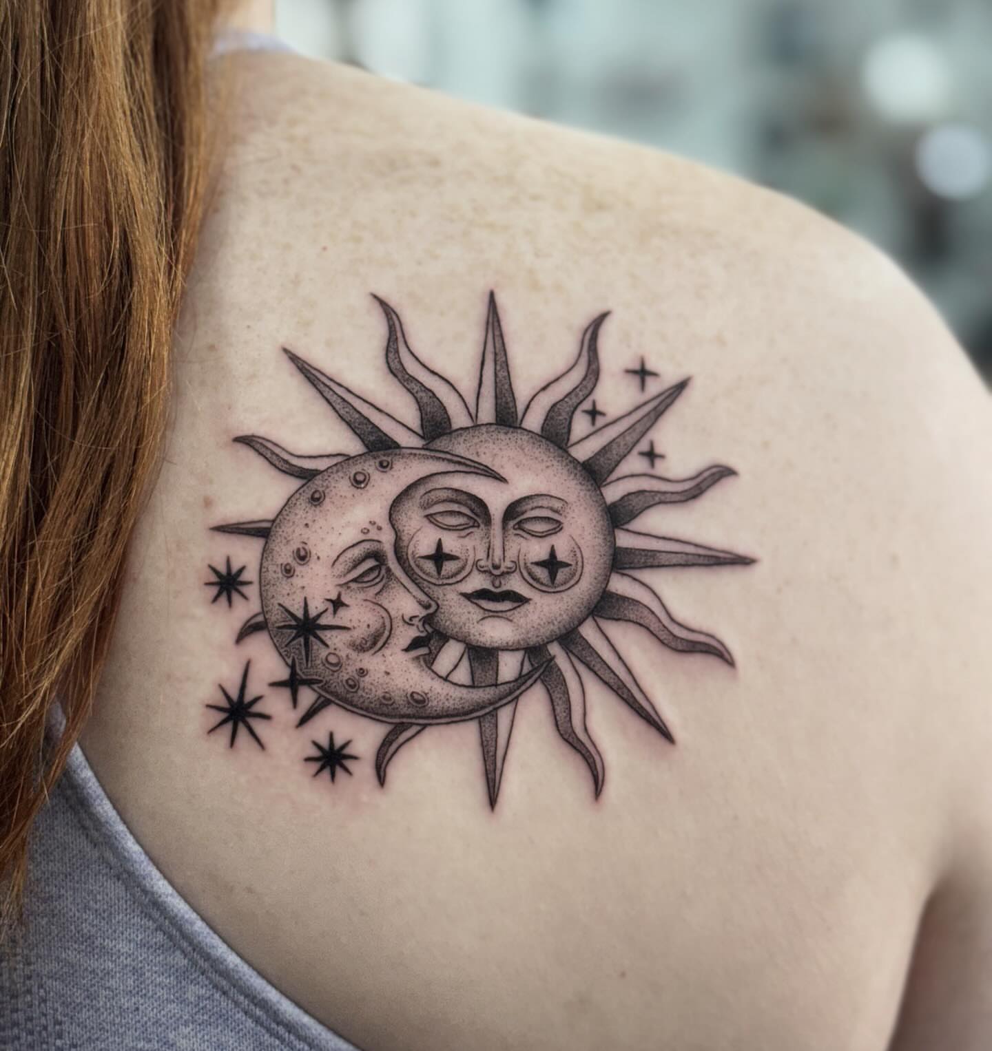 Sun and moon black and grey tattoo on the shoulder by Writhe Grey