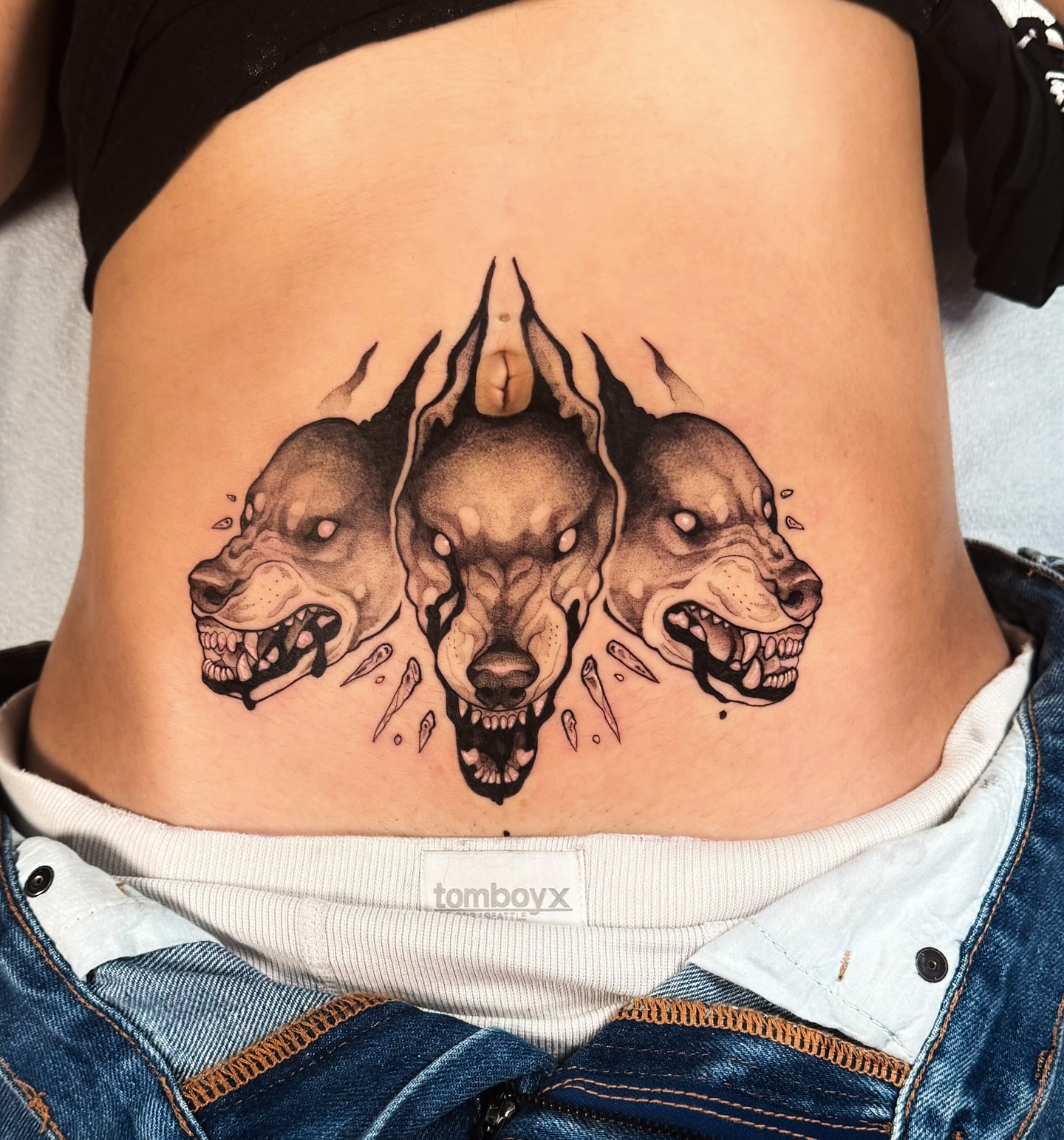 Three dogs black and grey tattoo on the ribs by Yasemin πΉπ·π¬π§ San Jose based tattoo artist