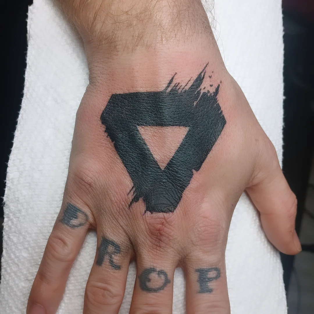 Abstract geometric shape black and grey tattoo on the hand by Cassieal Welch