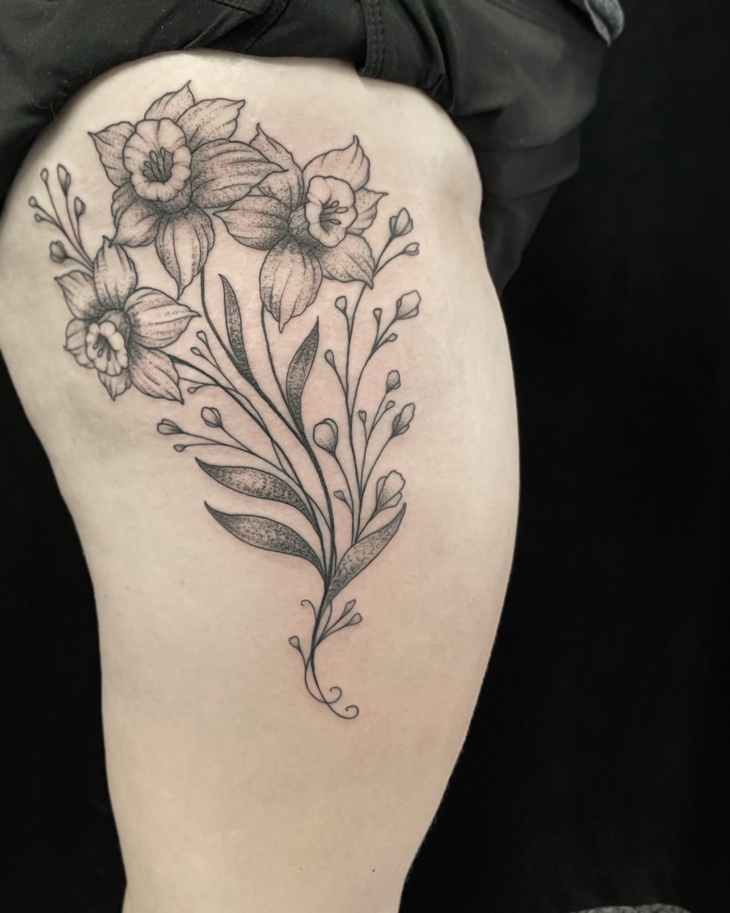 Daffodils and leaves dotwork tattoo on the thigh by Will McCoy (Tattooist), Murray, Utah