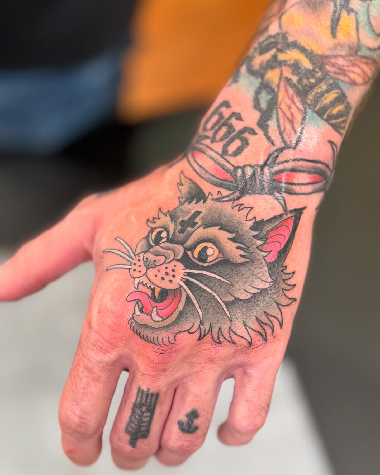 Cat head American traditional tattoo on the hand by Julio Ferrer