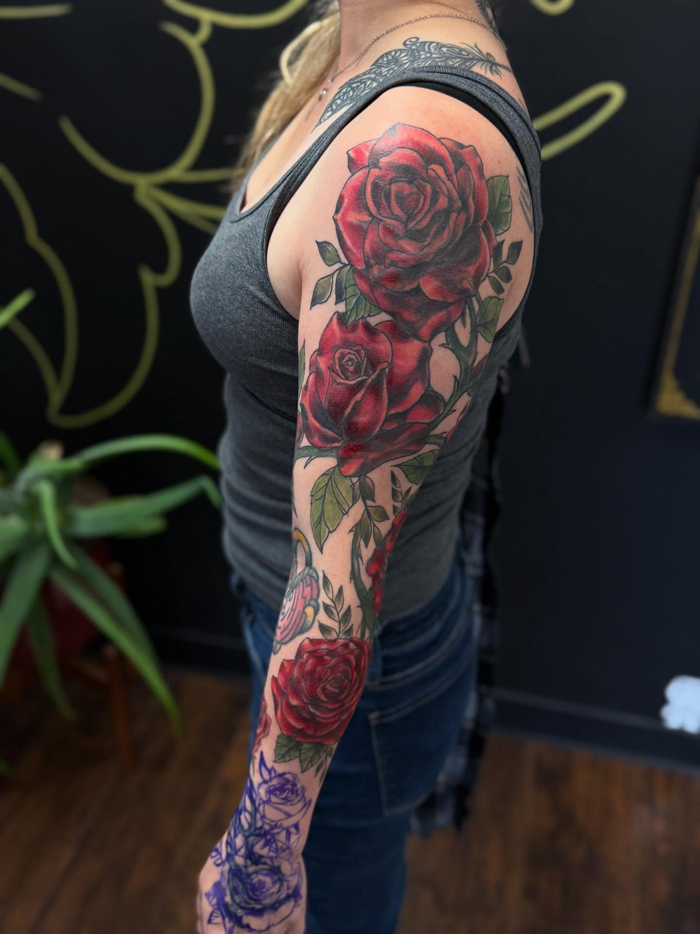 Roses realism tattoo on the upper arm by Tattoos By Trish