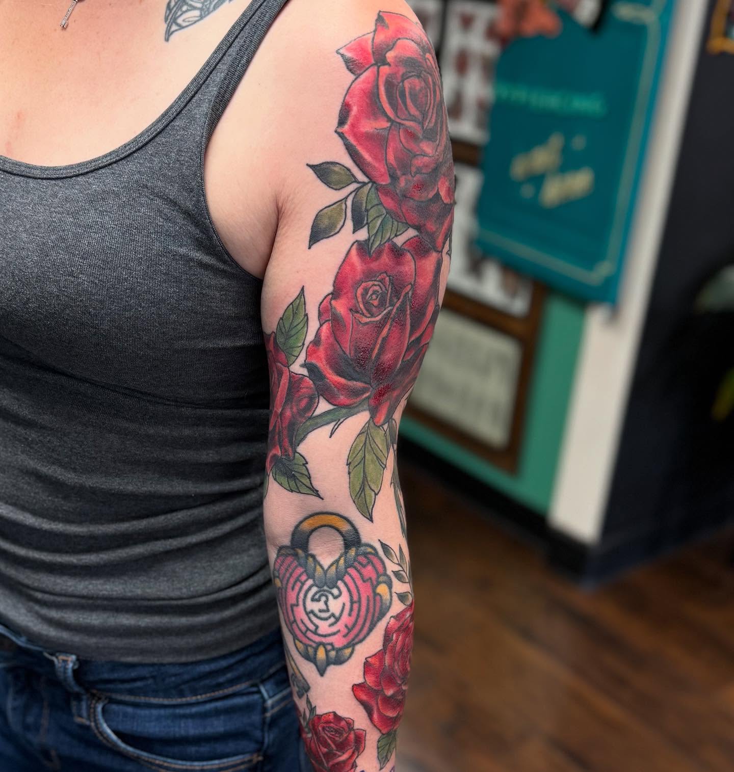 Roses and lock American traditional tattoo on the forearm by Tattoos By Trish