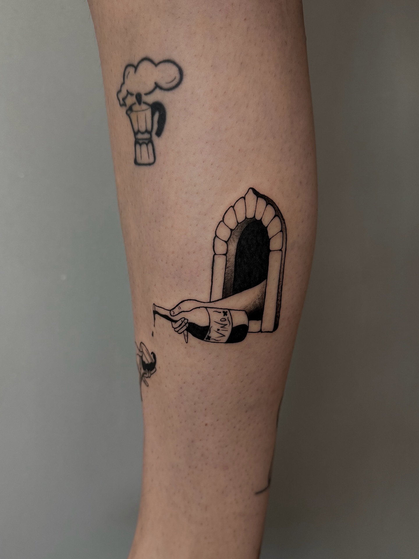 Coffee maker and hand black and grey tattoo on the forearm by Rebel milly Tattoo