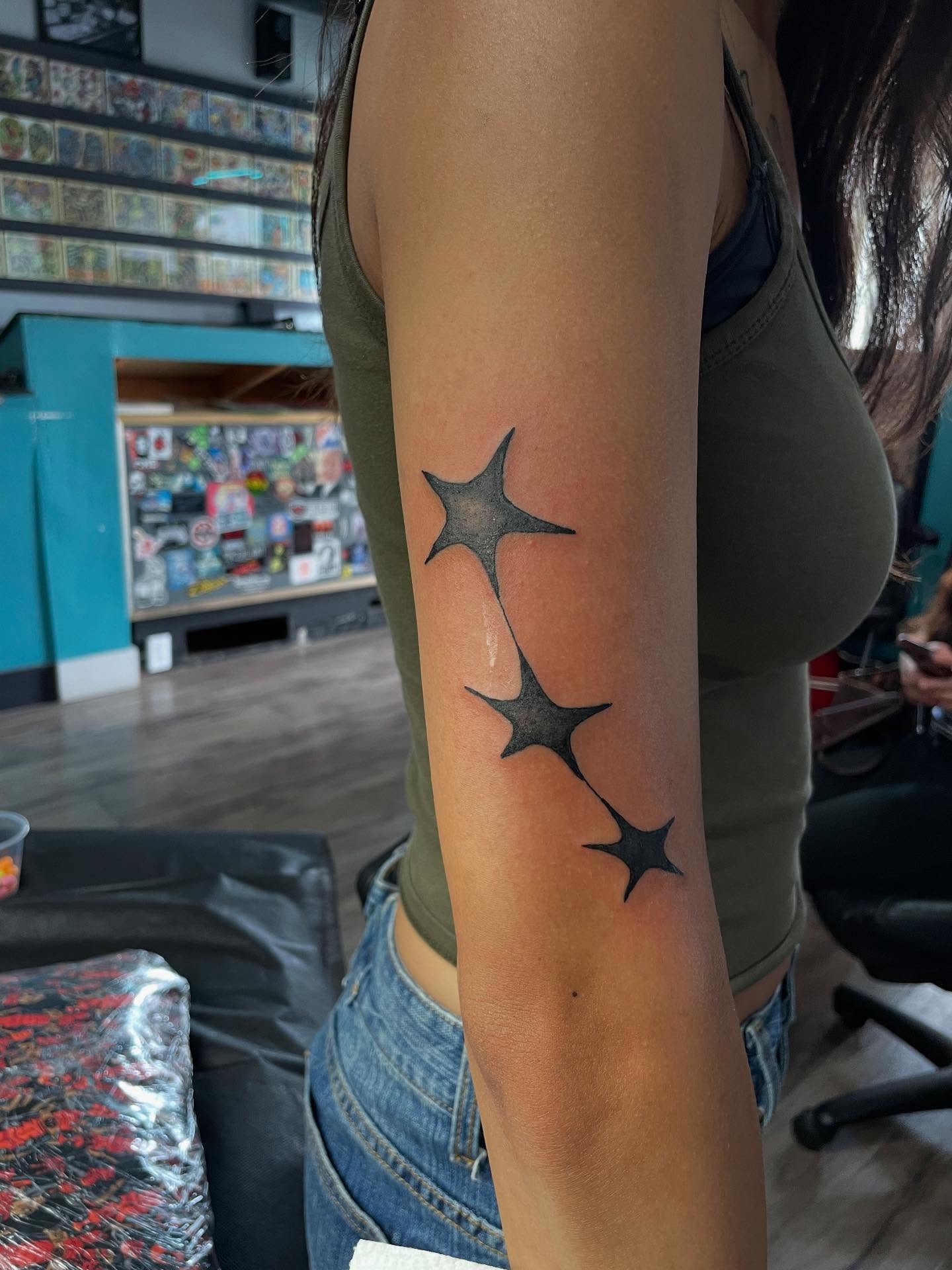 Stars black and grey tattoo on the forearm by Mark Johnson [Tattoo Artist]