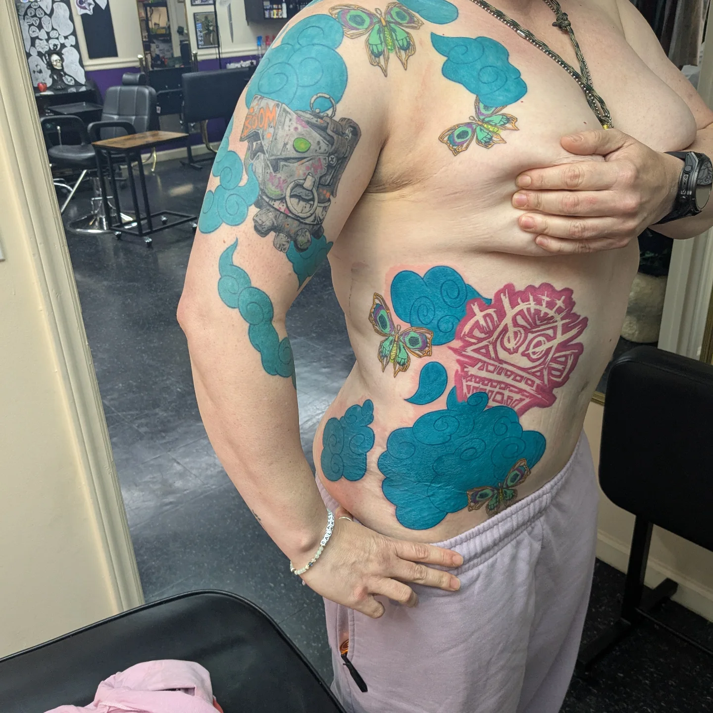 Butterflies and clouds dotwork tattoo on the torso by Jessica Thomas Fleischman, Morganton, North Carolina