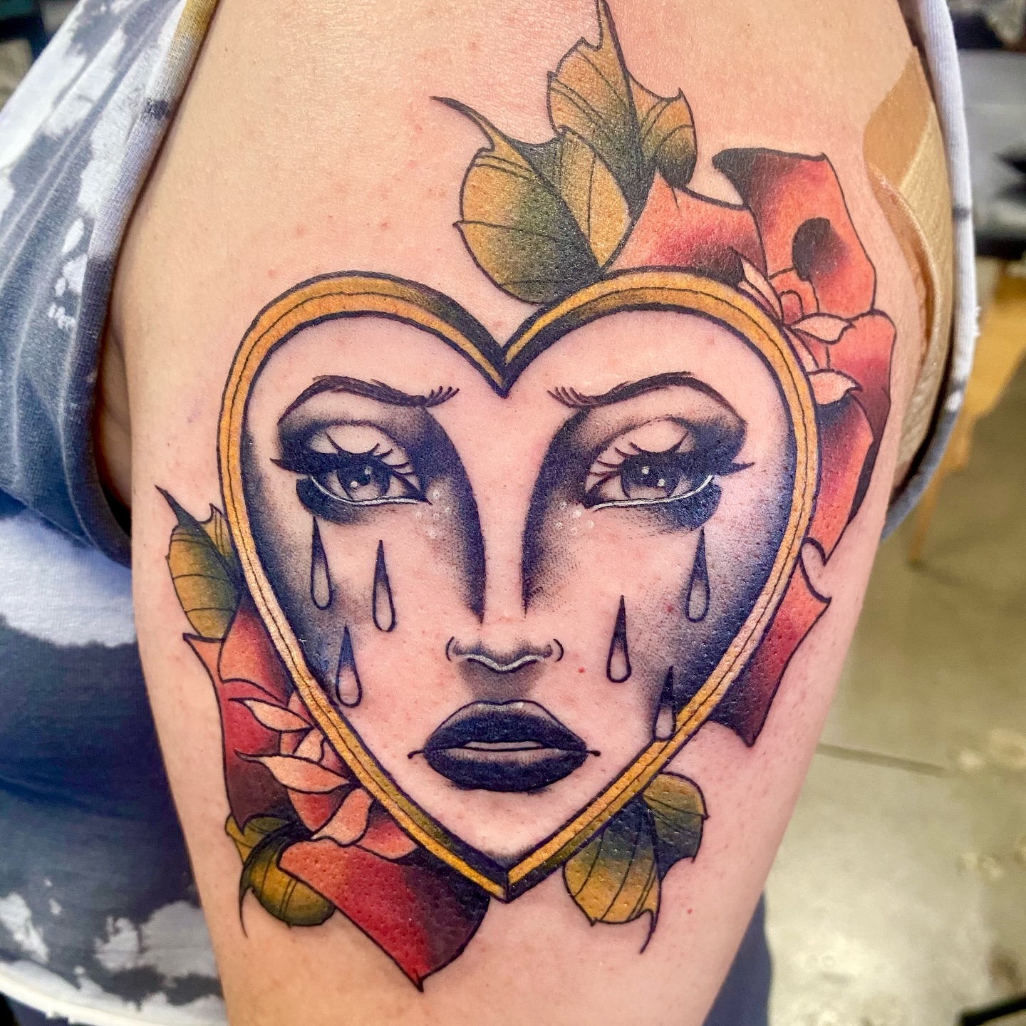 Heart-shaped face American traditional tattoo on the thigh by Ashley Lin Las Vegas Tattoo Artist