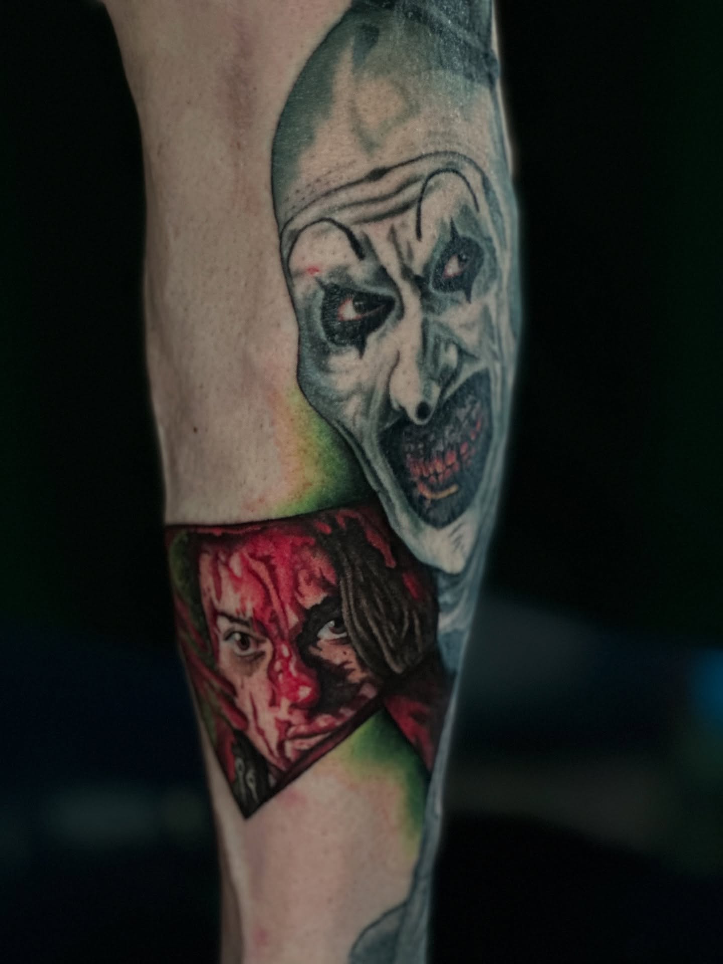 Clown and victim realism tattoo on the forearm by Sam Minneci
