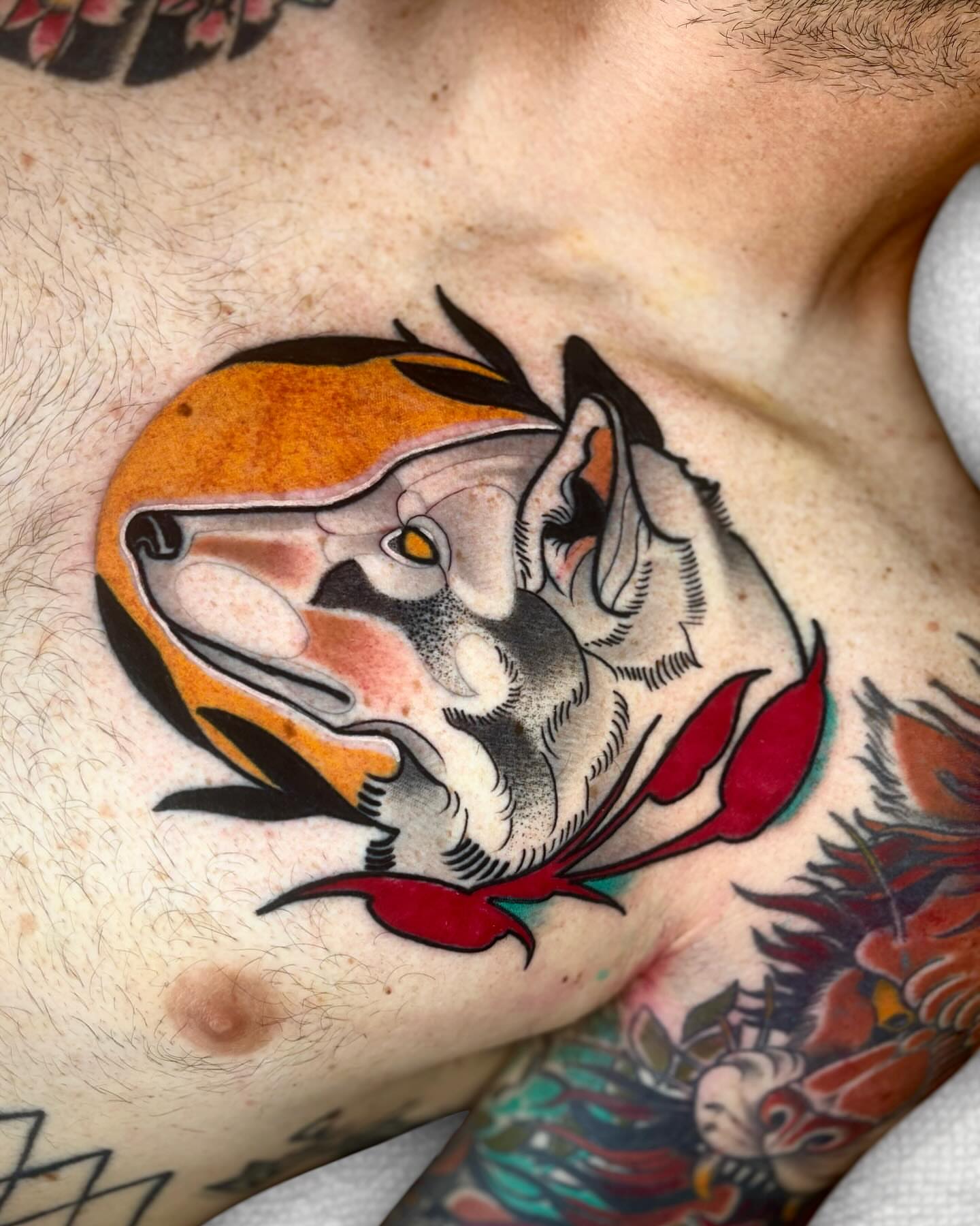 Wolf American traditional tattoo on the chest by Todd Showdown