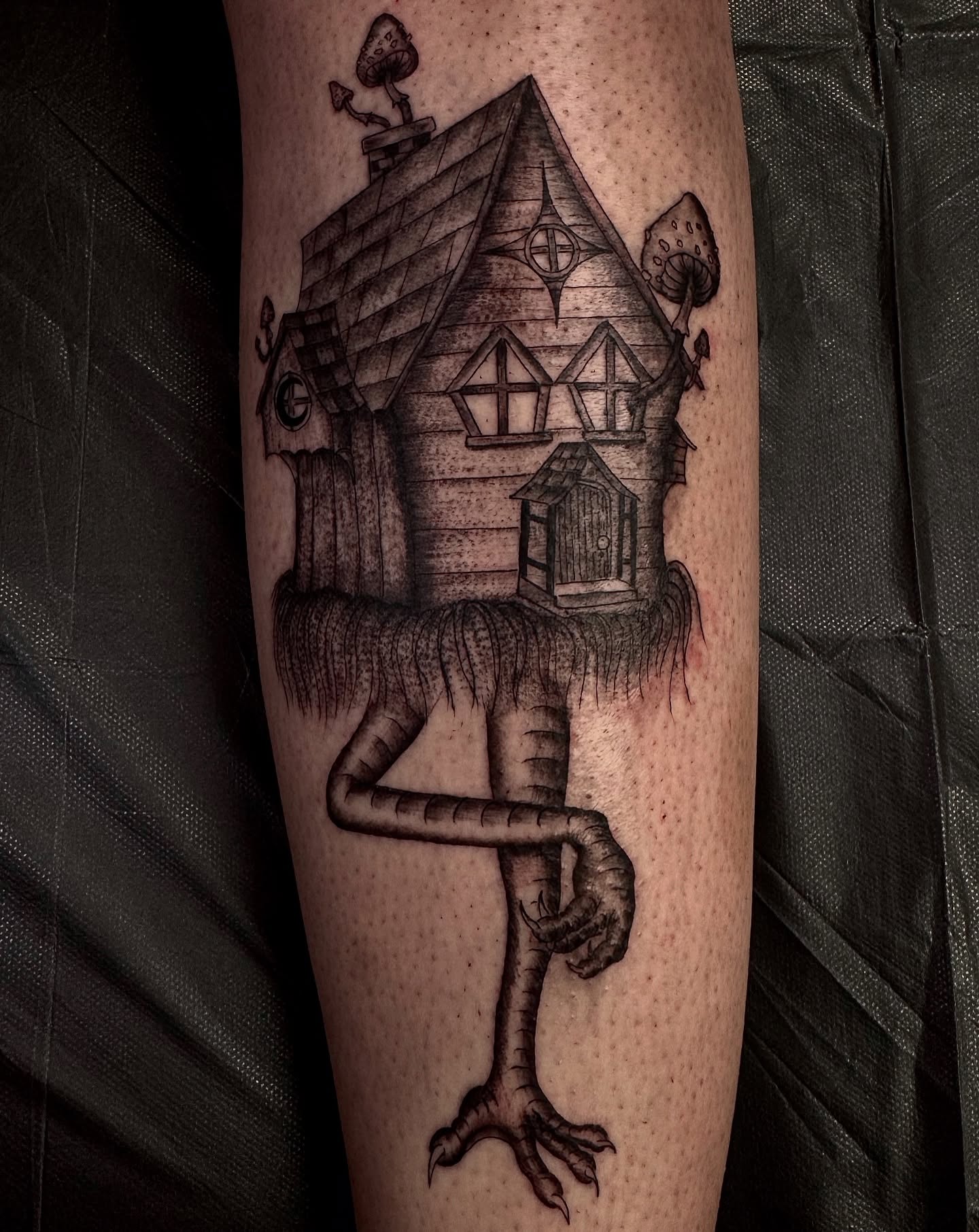 House with tentacles dark realism tattoo on the forearm by Mika