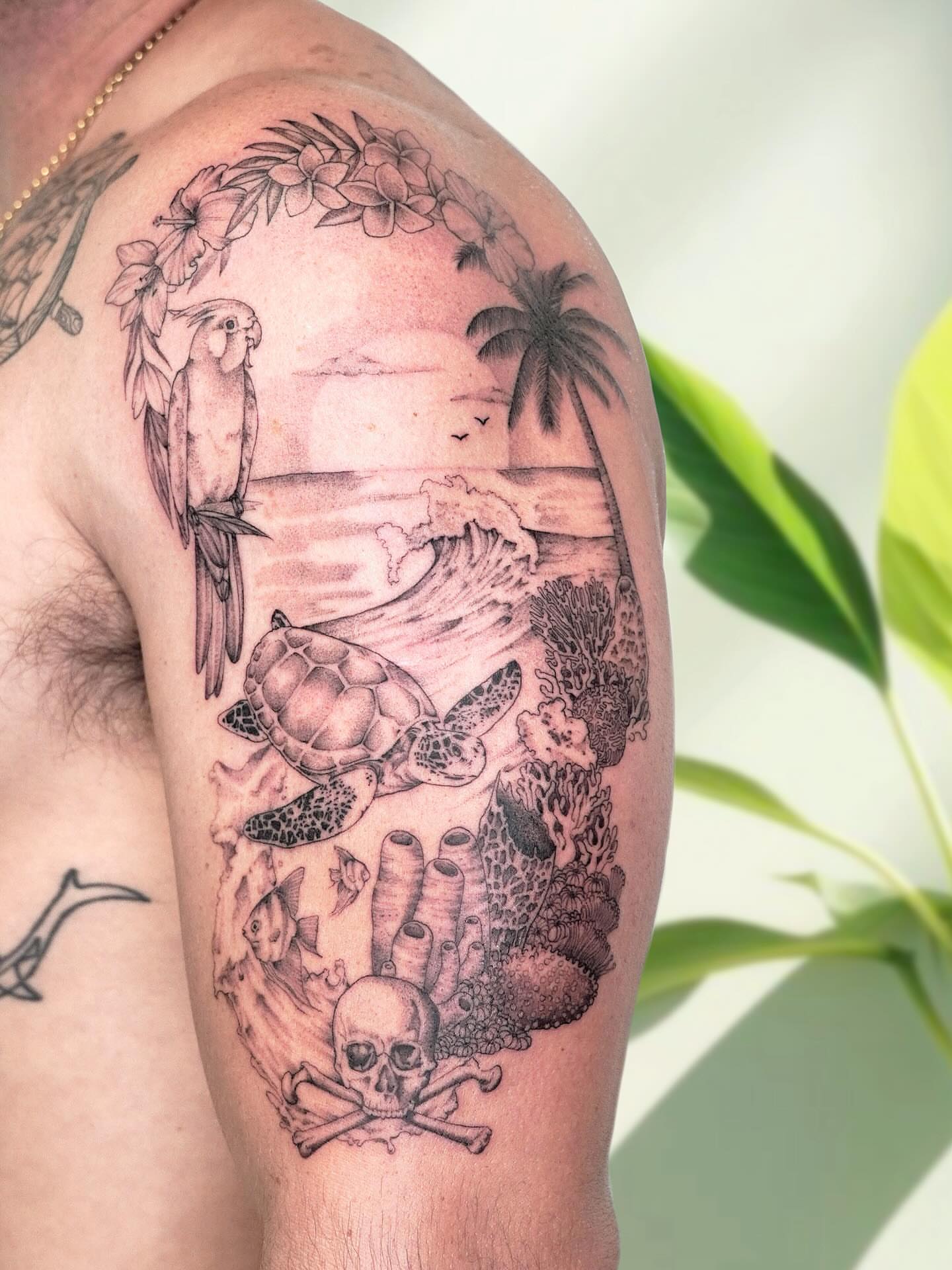 Beach scene realism tattoo on the upper arm by Marianna D D King