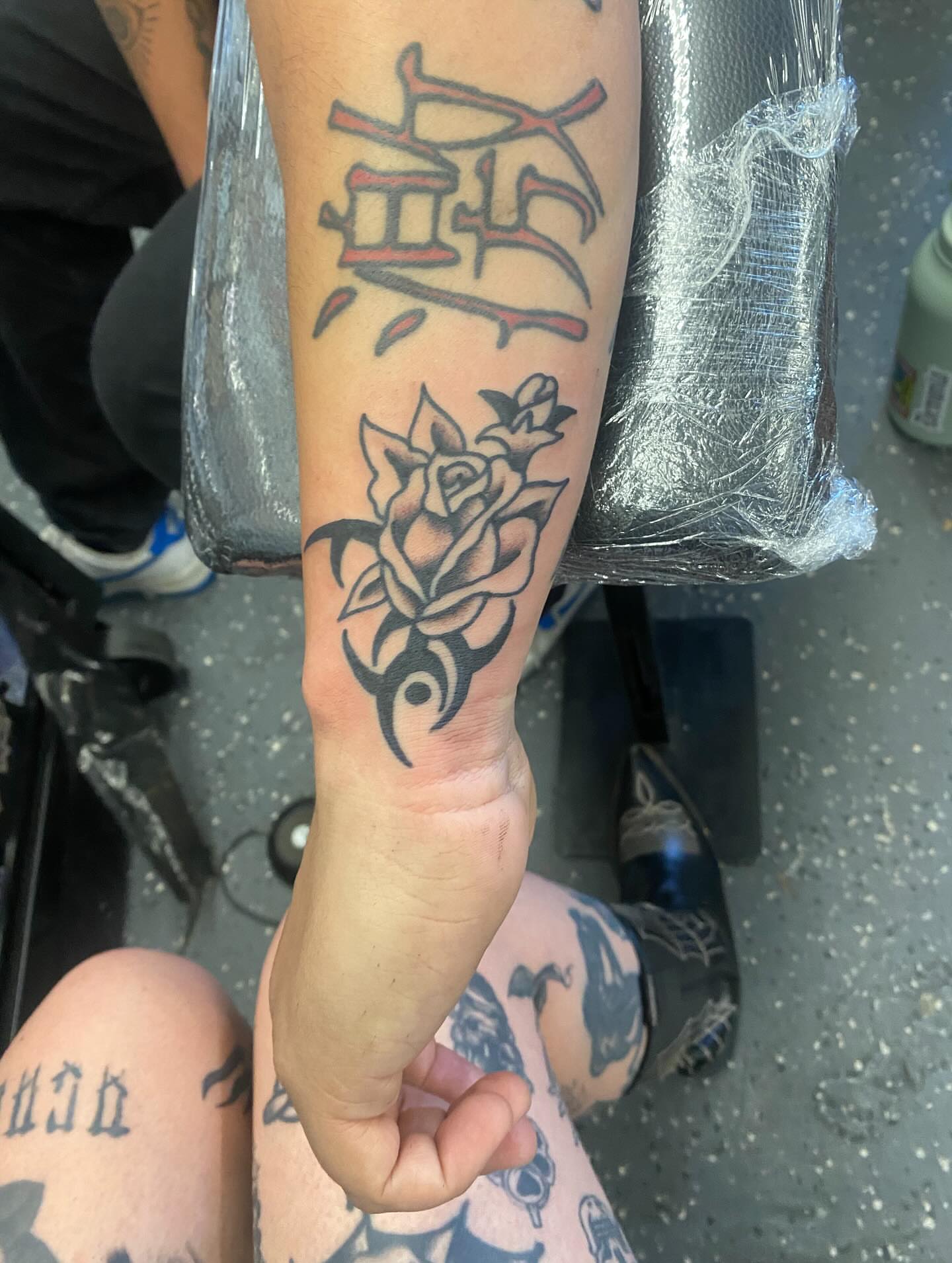 Rose and tribal design tribal tattoo on the forearm by Payton Prentice