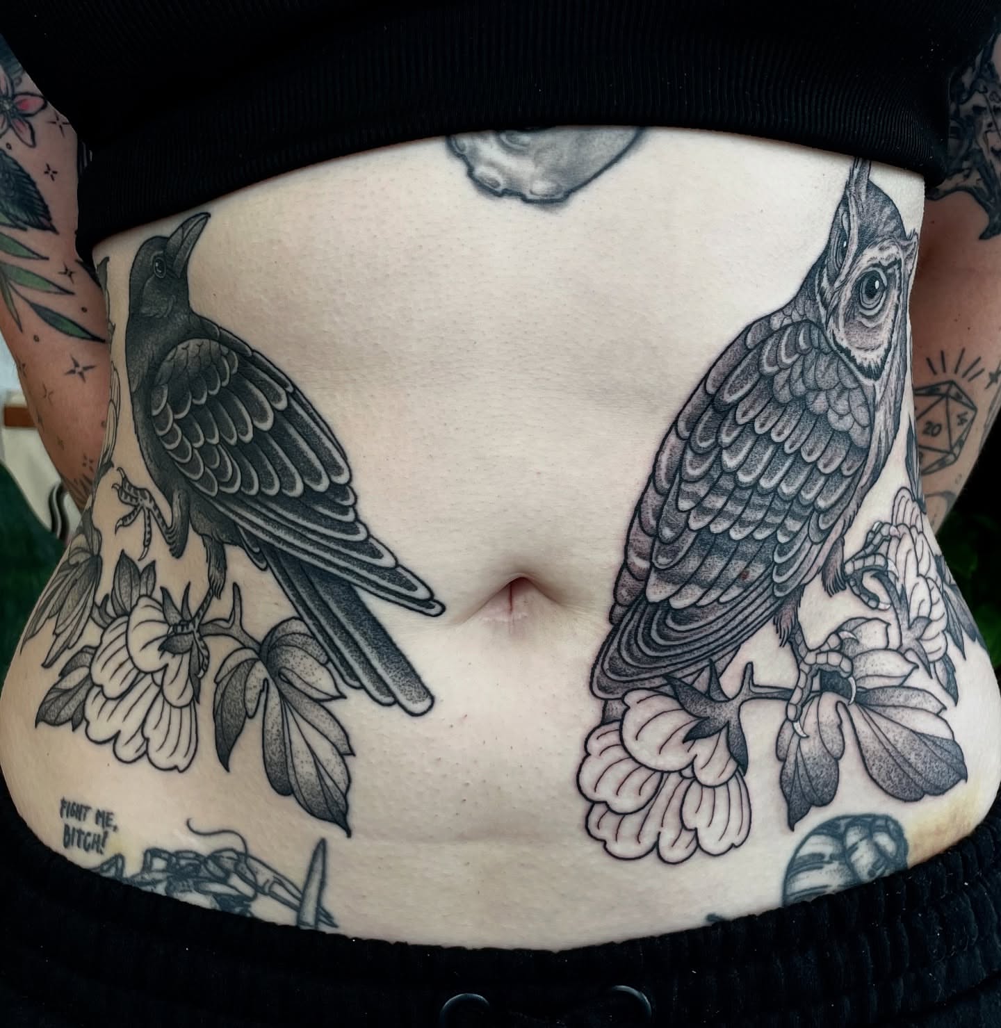 Birds and flowers black and grey tattoo on the torso by Emily Lux