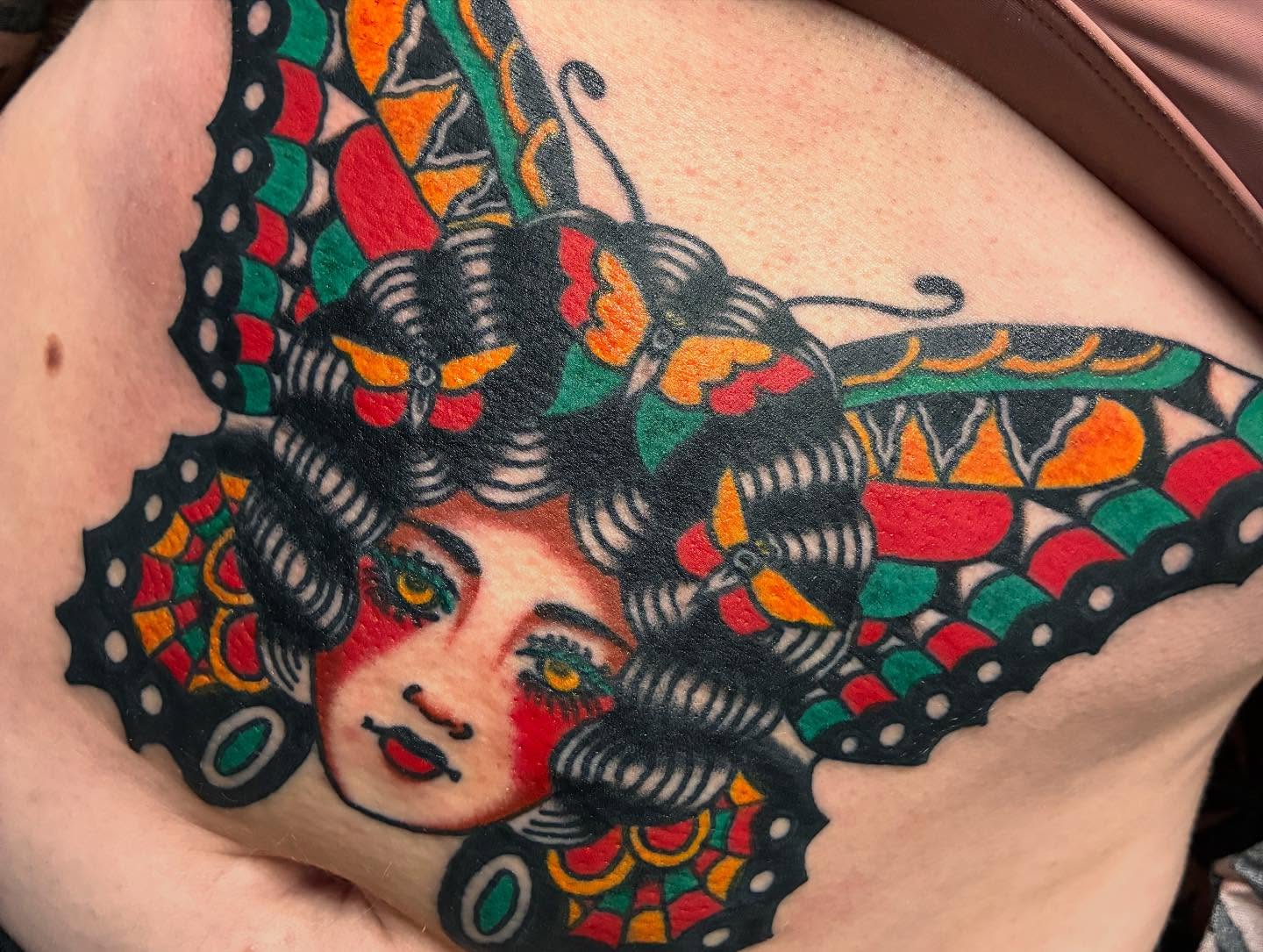 Woman with butterflies American traditional tattoo on the chest by Chrissie
