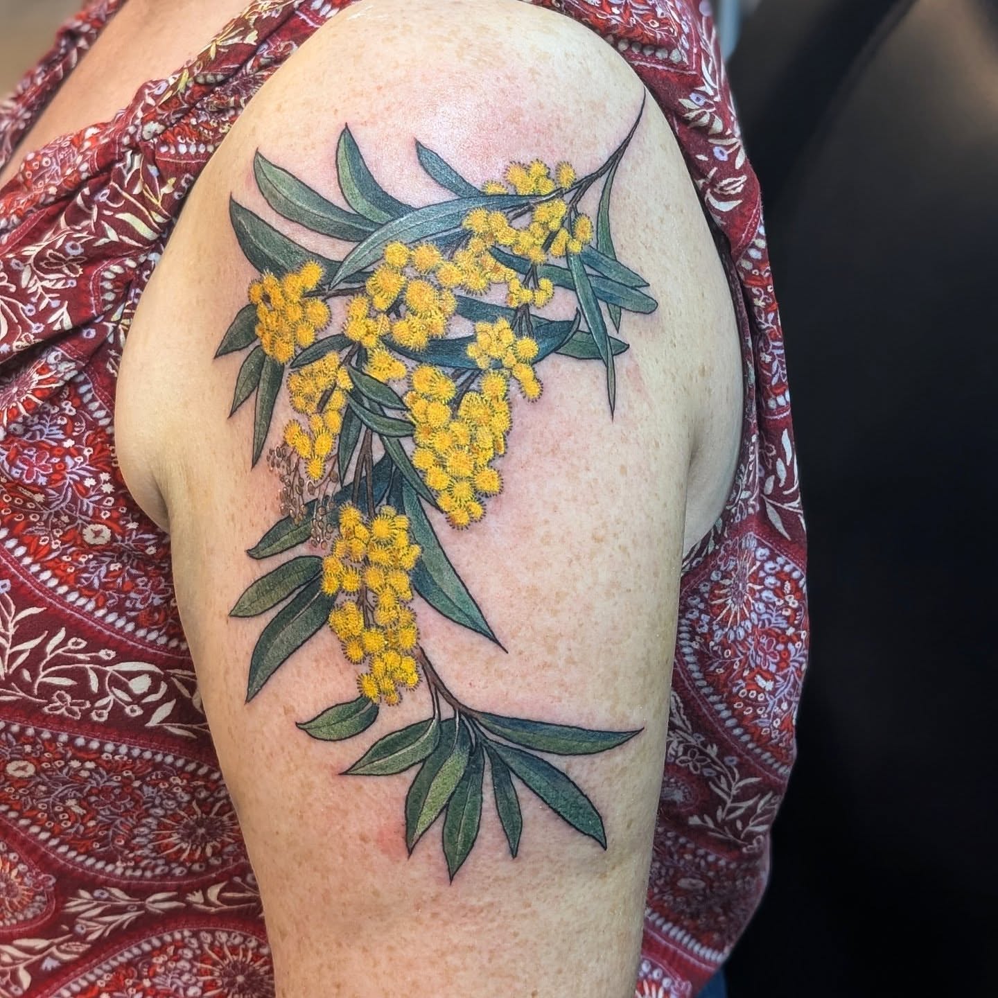 Wattle flowers realism tattoo on the shoulder by Ashton Allen-Ruiz, Portland, Oregon